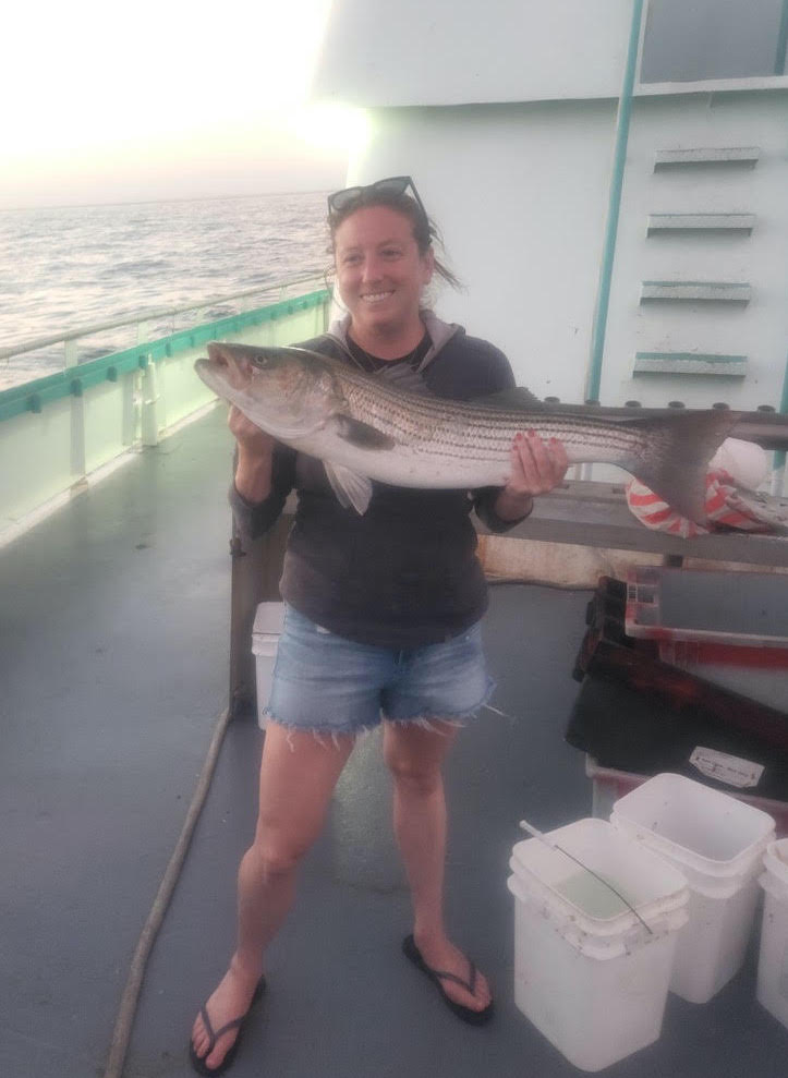 a person holding a fish in the water