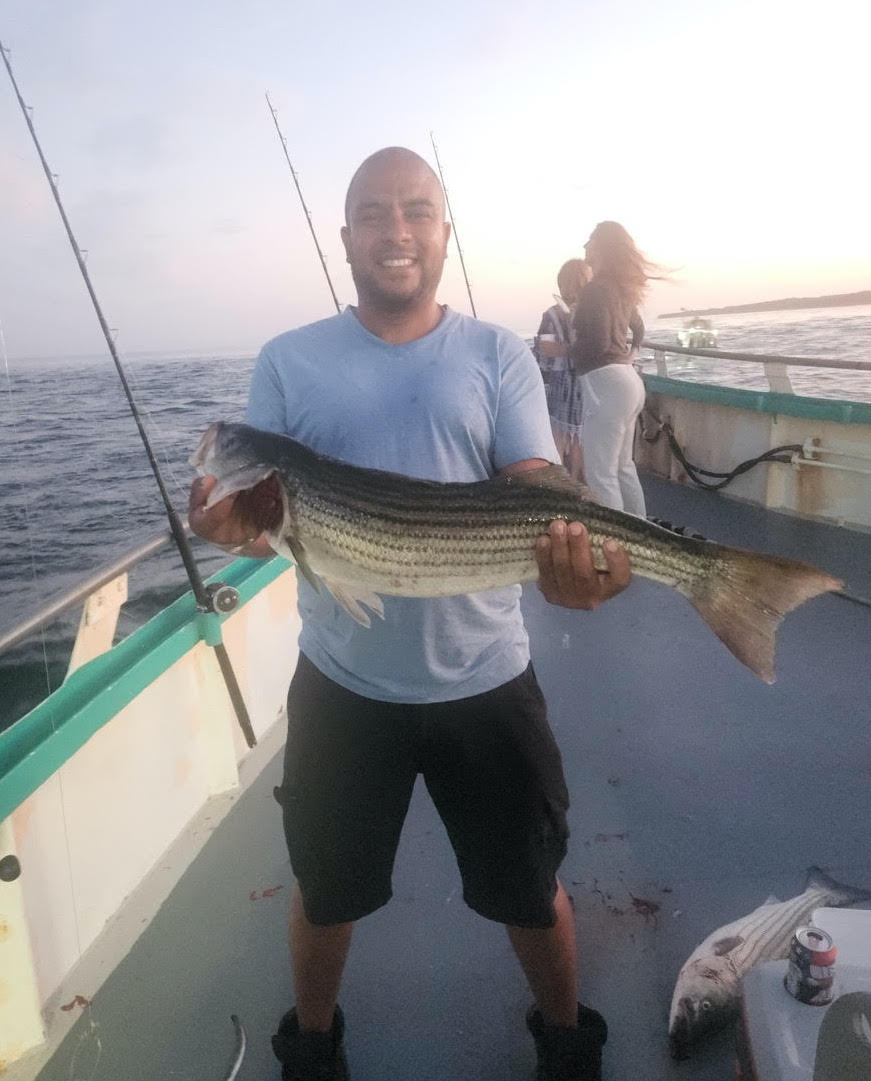 a man holding a fish in the water