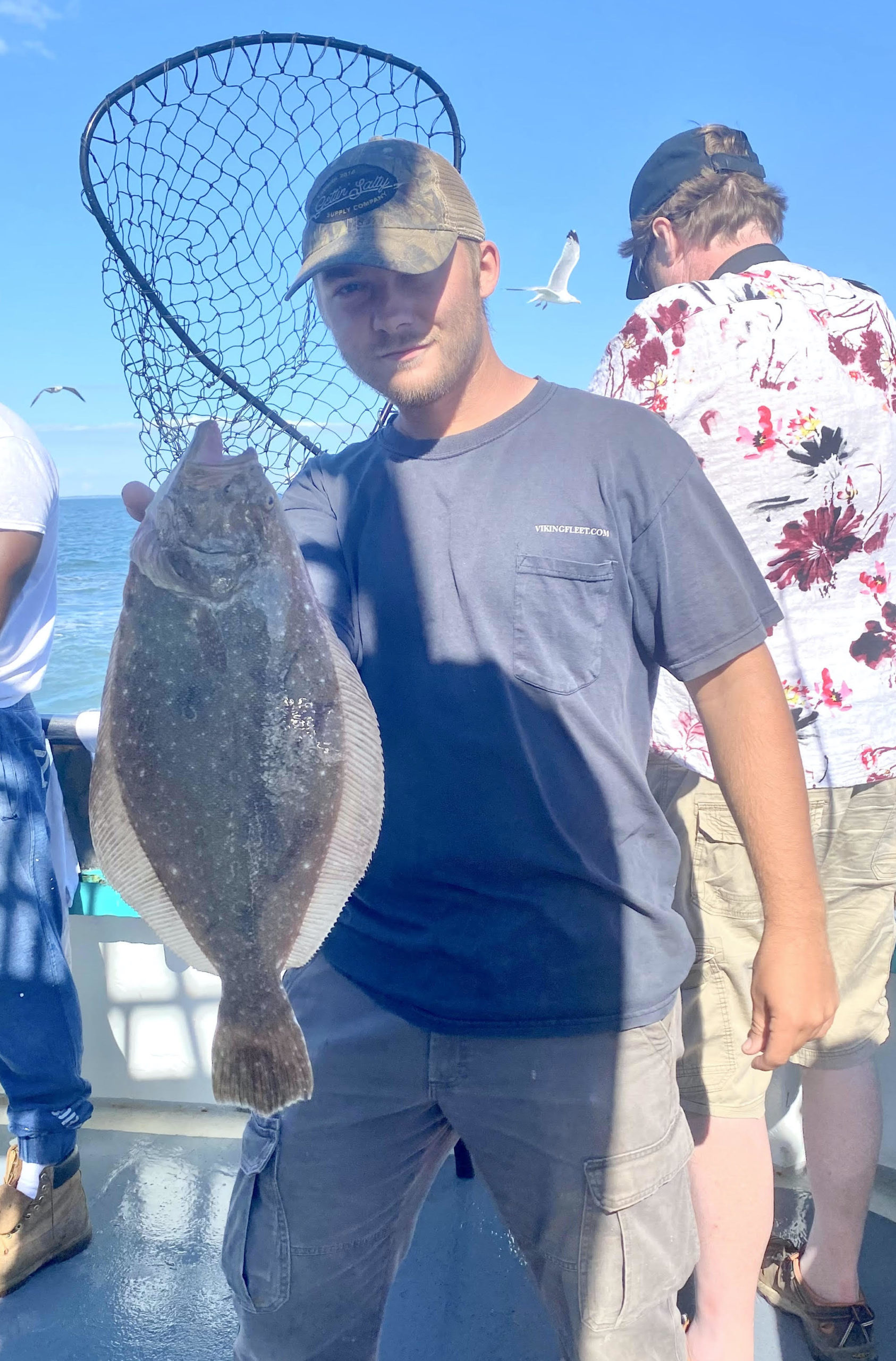 a couple of men standing next to a statue of a man