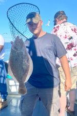 a couple of men standing next to a statue of a man