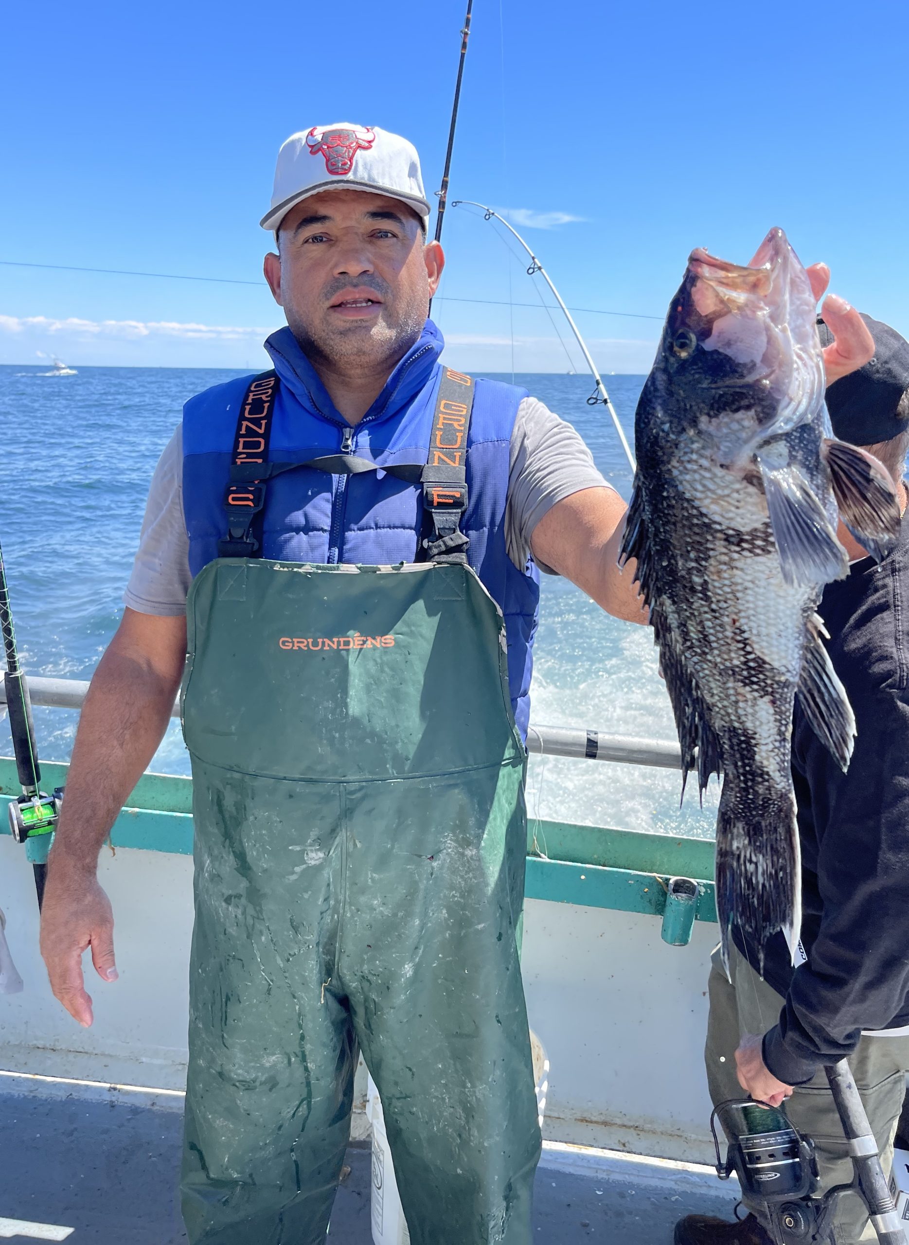 a man holding a fish in the water