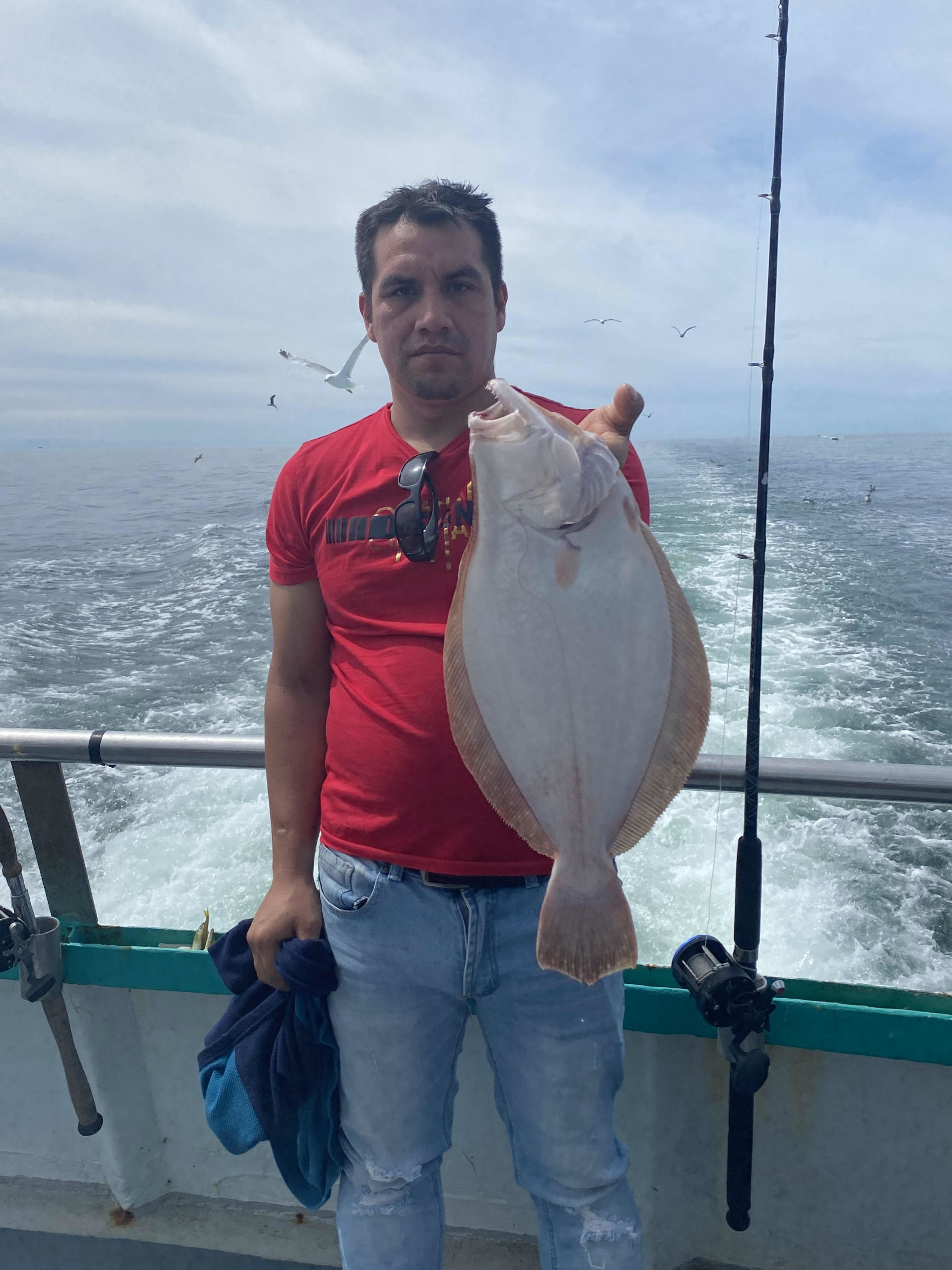 a man holding a fish in the water