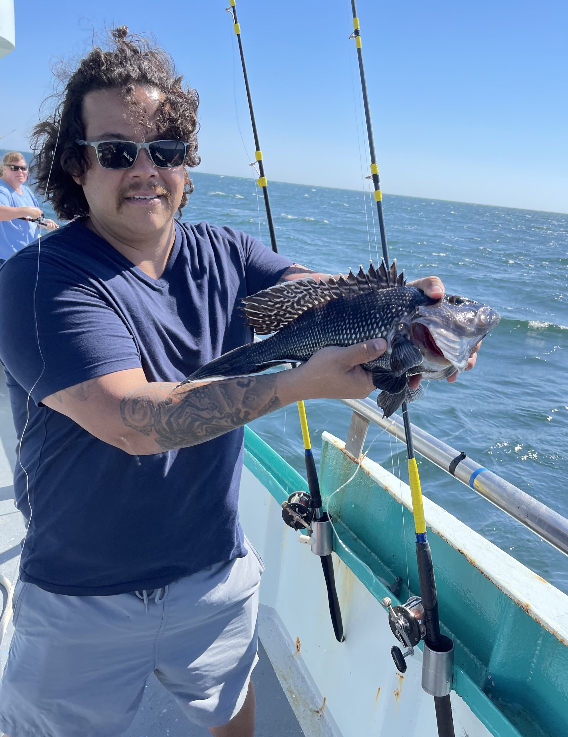 a man standing next to a body of water