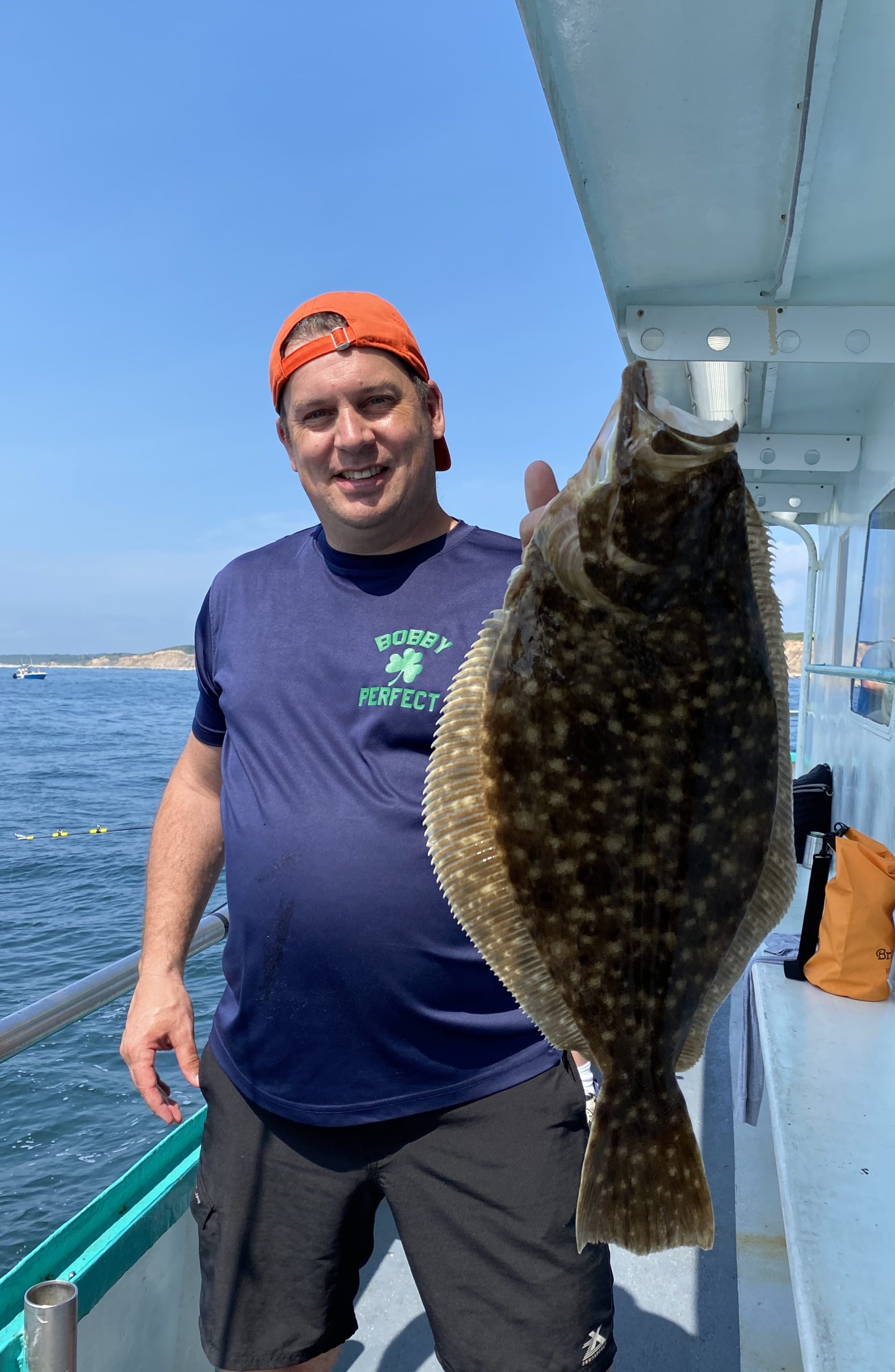 a man holding a fish in the water