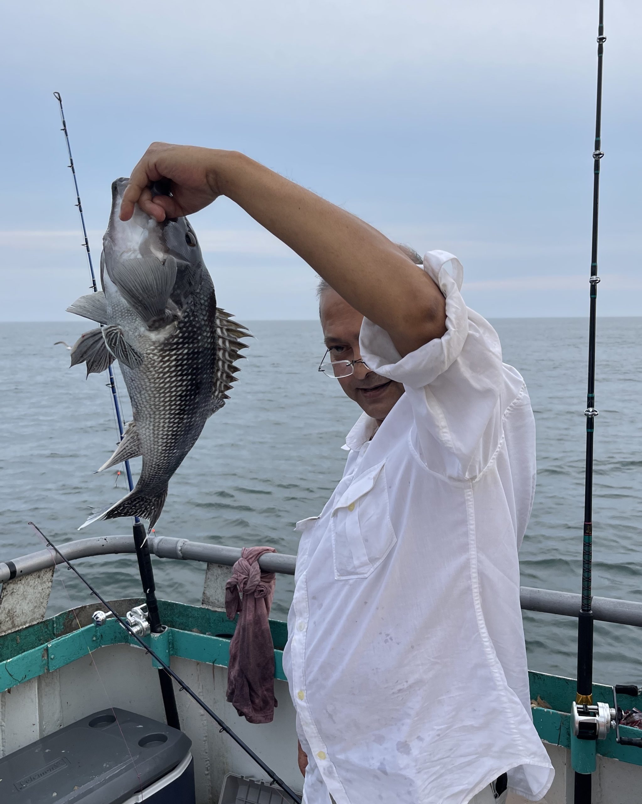 a person holding a fish in the water