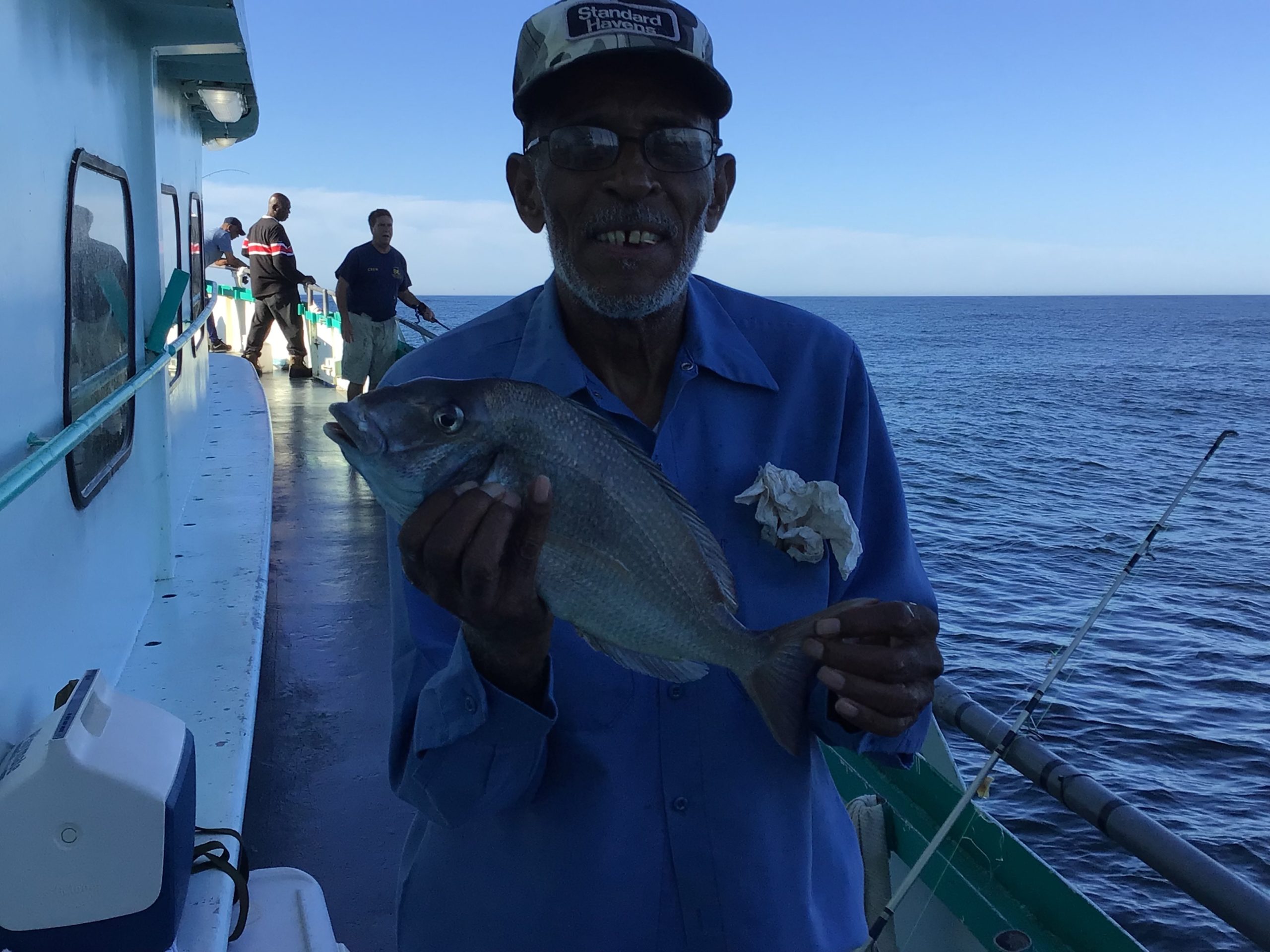 a man holding a fish in the water