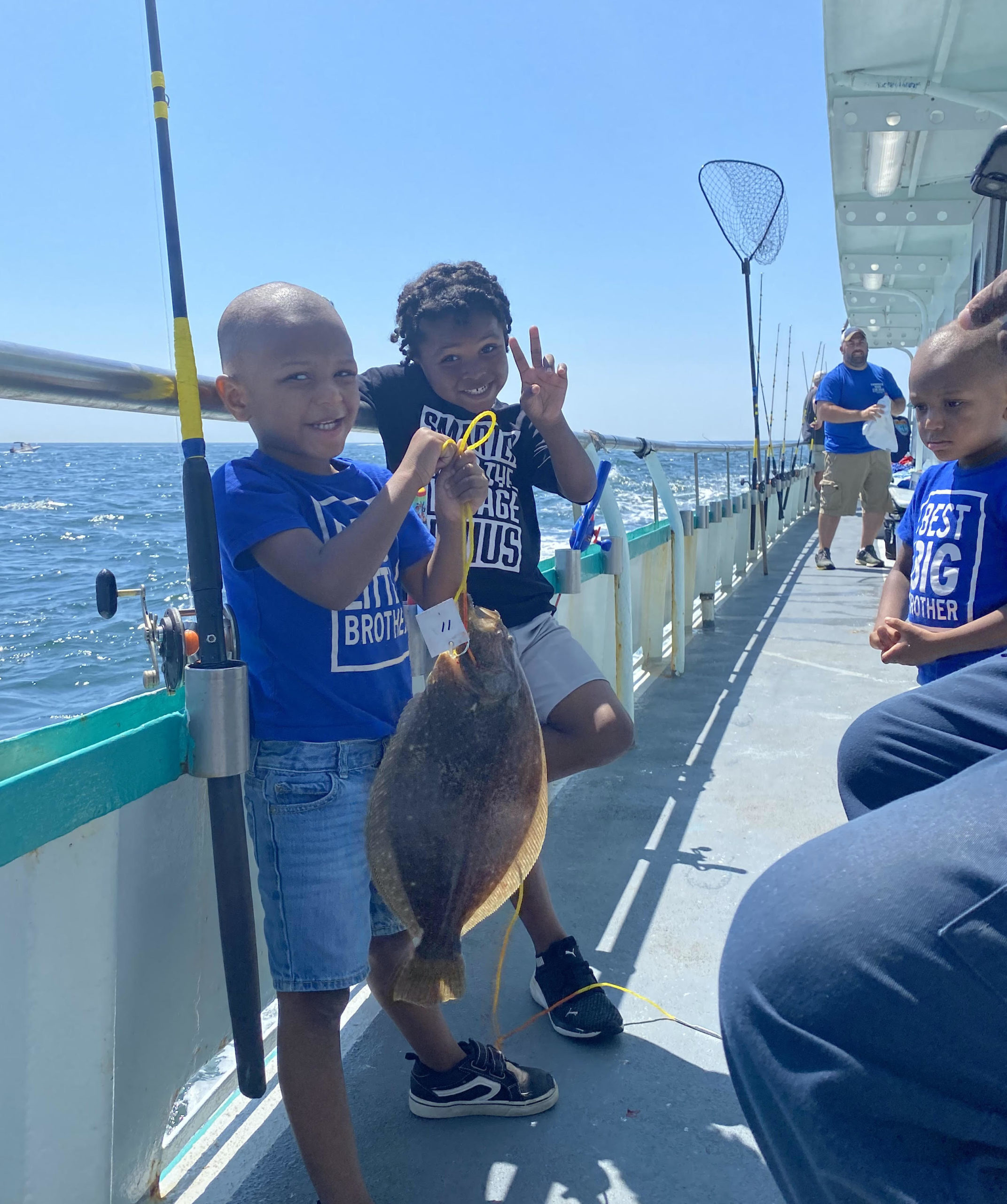 a little boy that is standing on a boat