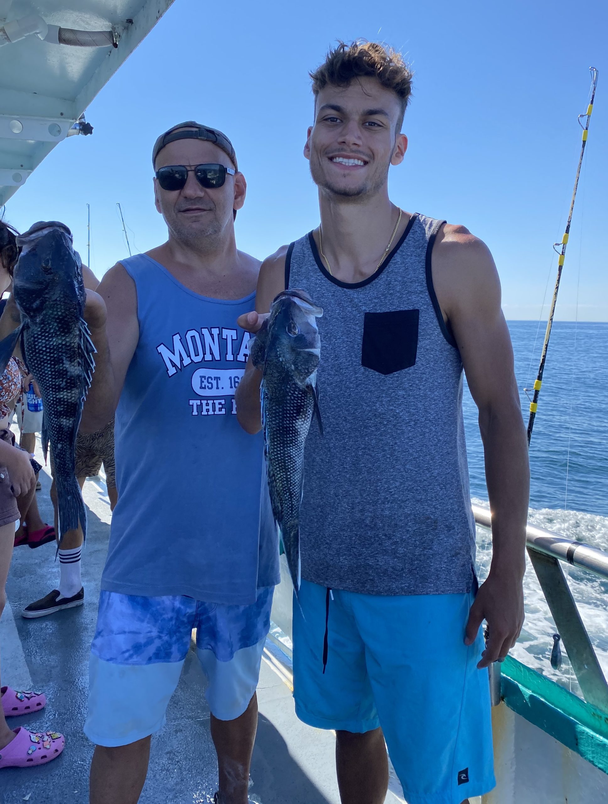 a group of people standing next to a body of water