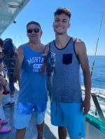 a group of people standing next to a body of water