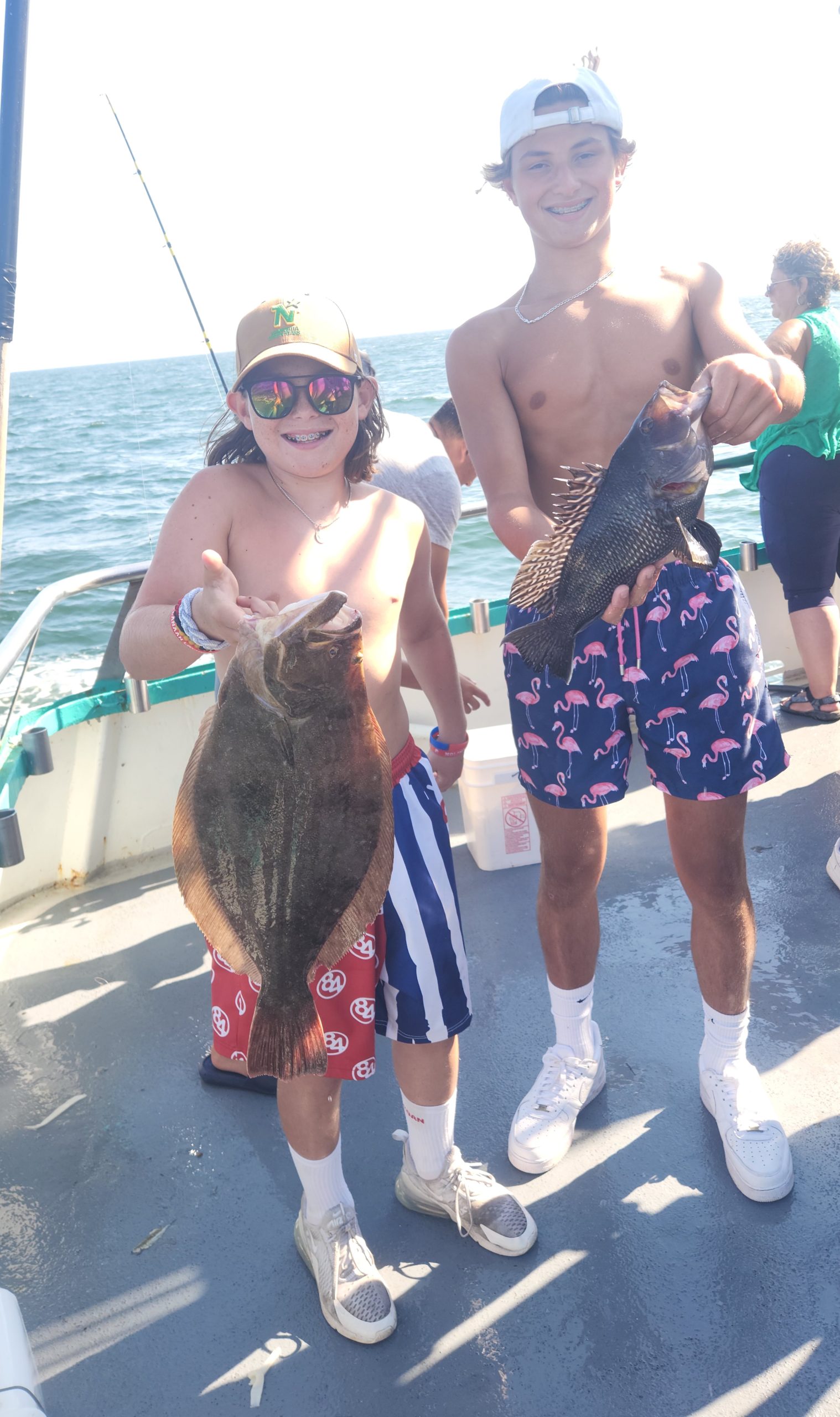 a woman wearing a hat and sunglasses posing for the camera