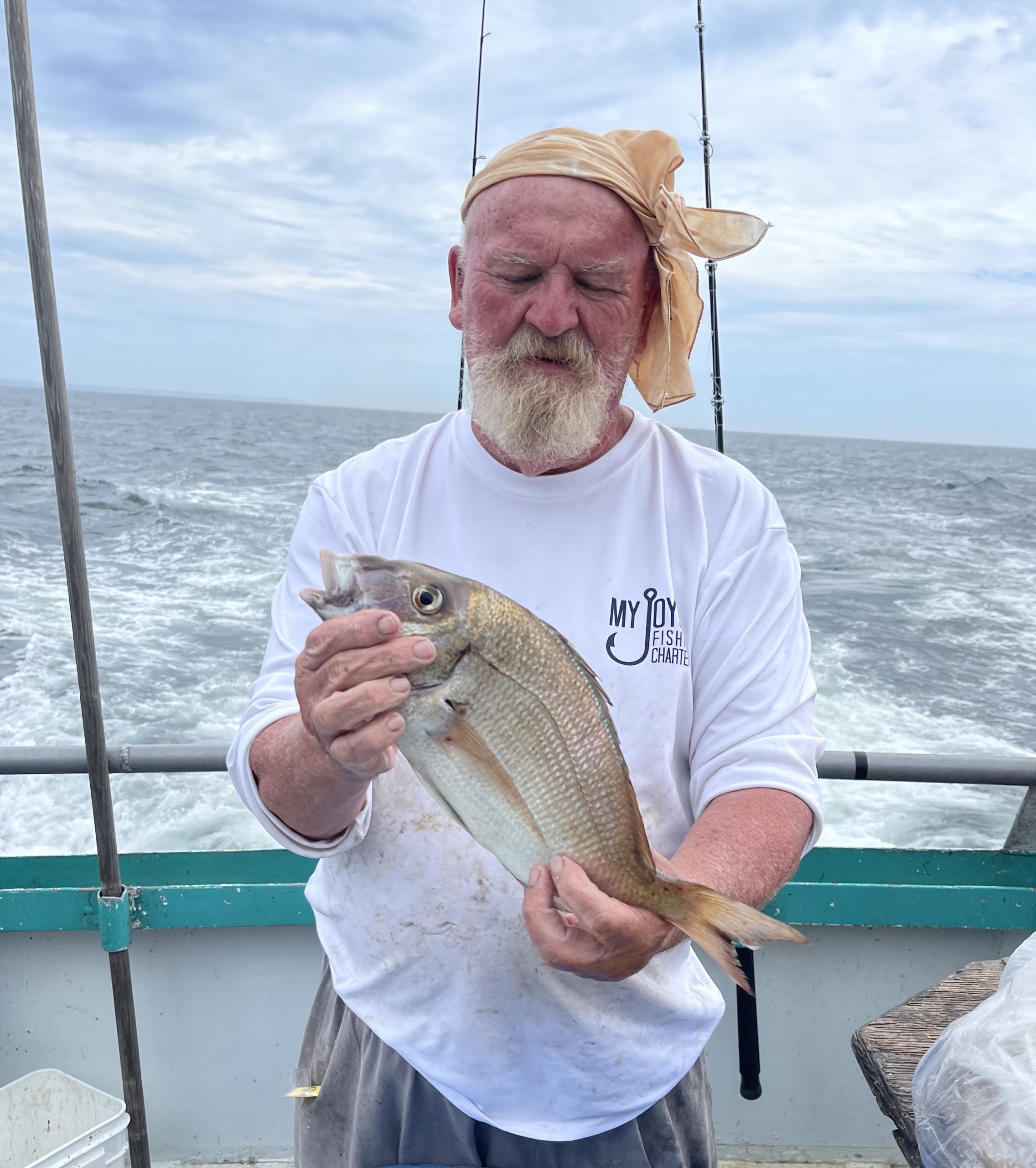 a man holding a fish in the water
