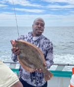 a person standing next to a body of water