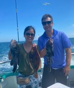 a man and a woman holding a fish
