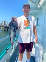 a man holding a fish
