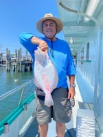 a man holding a fish