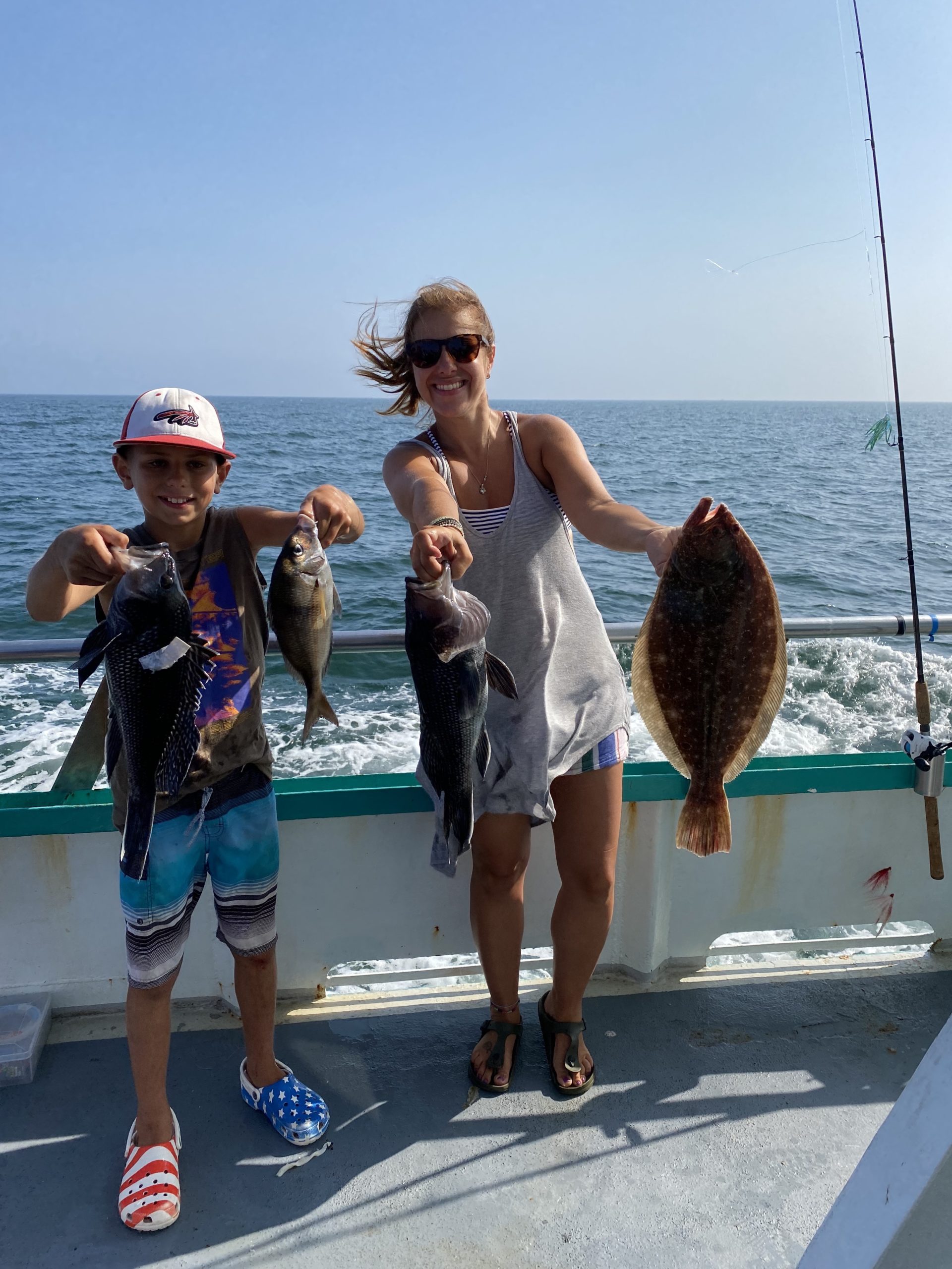 a group of people standing next to a body of water
