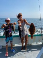 a group of people standing next to a body of water