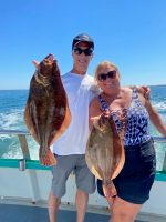 a person holding a fish in the water
