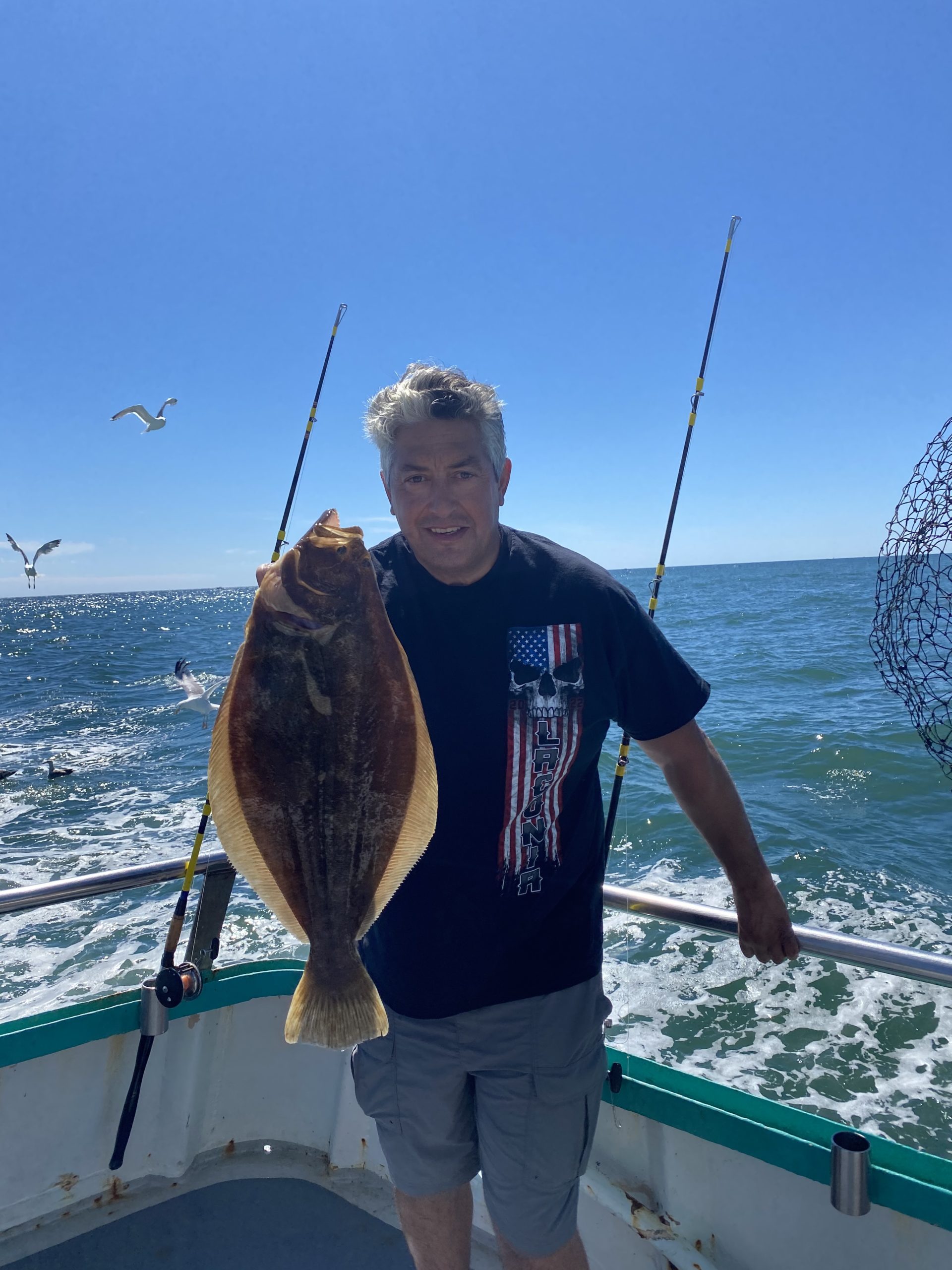 a man holding a fish in the water