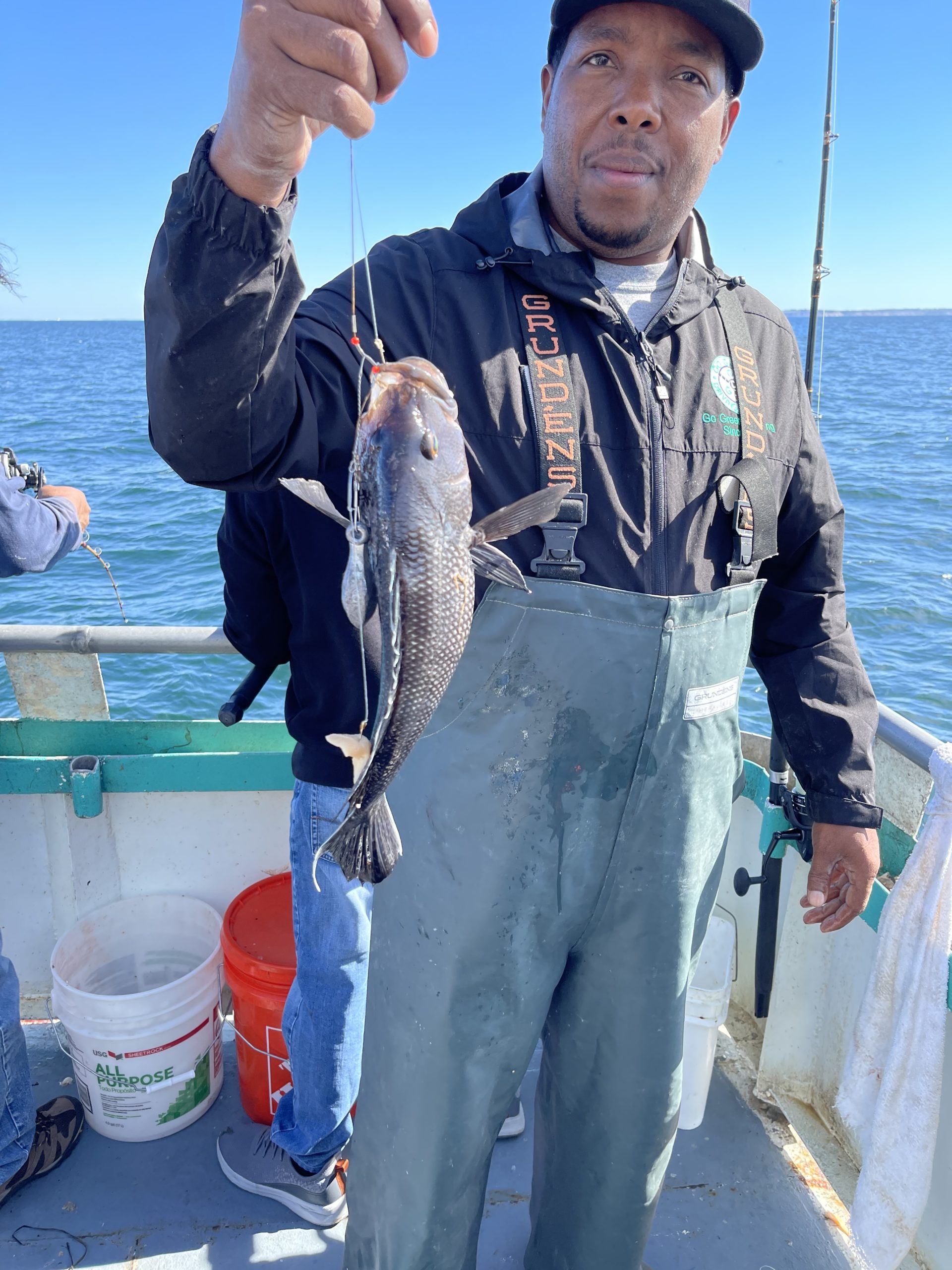 a man holding a fish in the water
