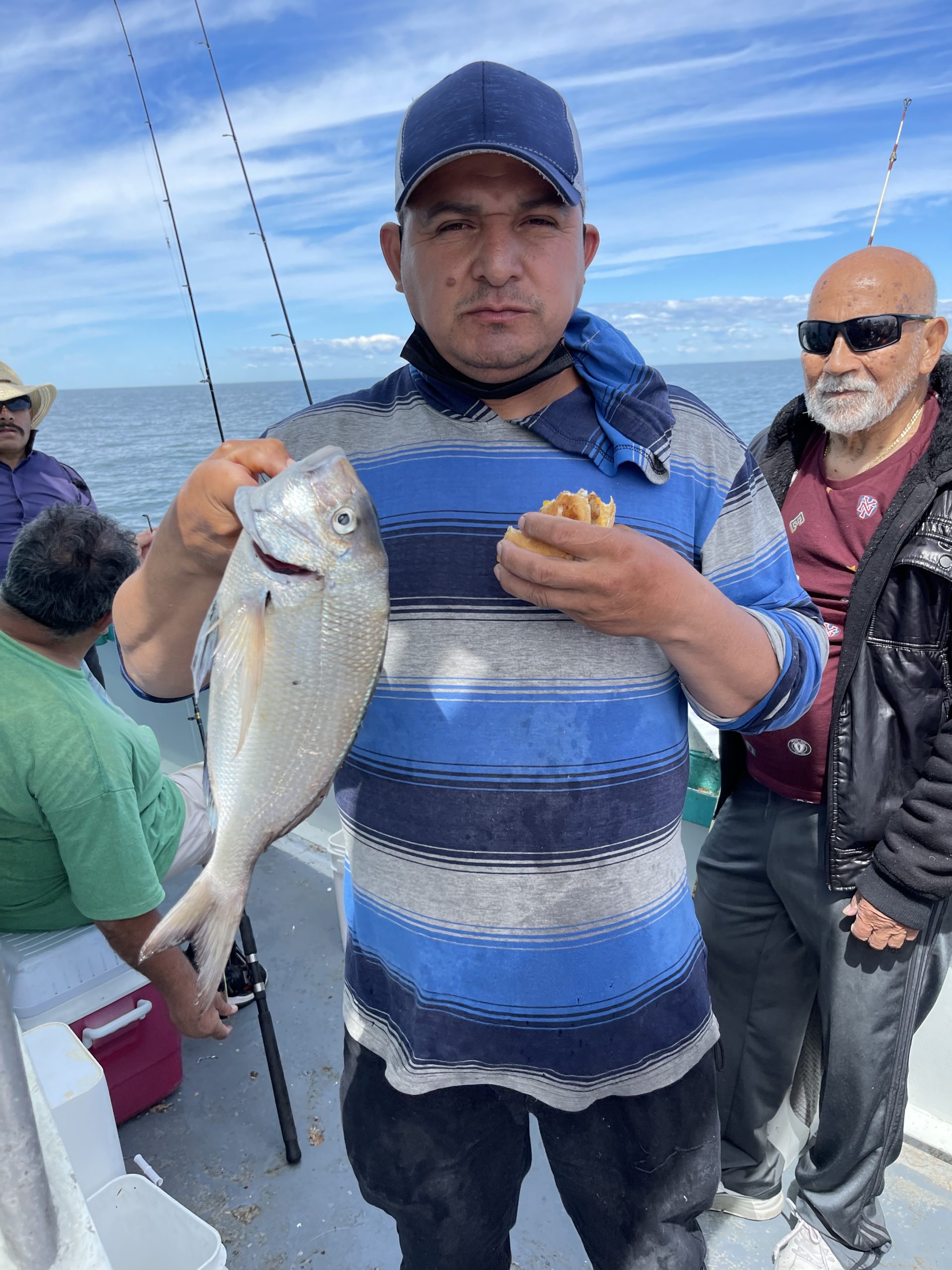 a person holding a fish on a boat