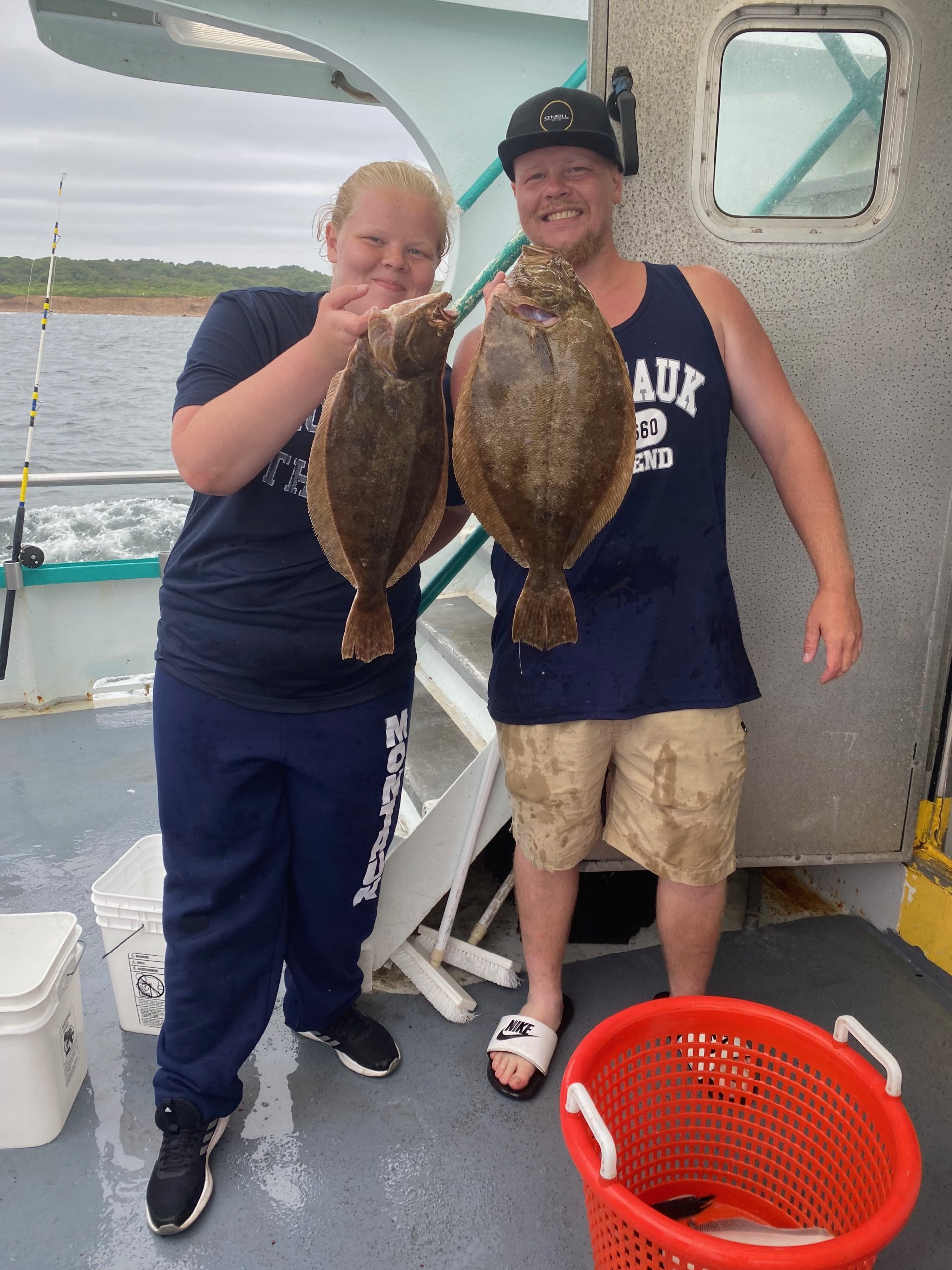 a person holding a fish posing for the camera