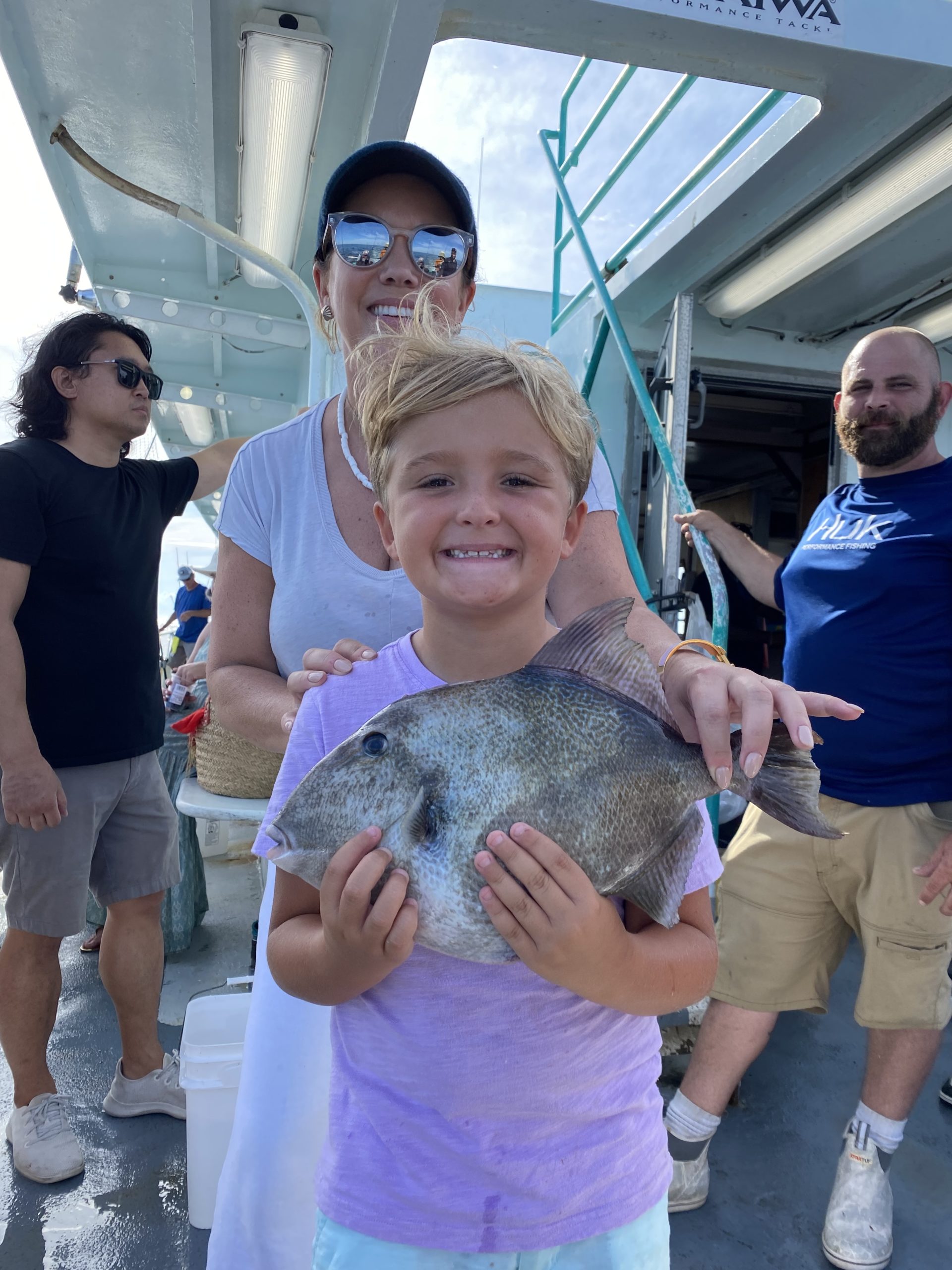 a small child is holding a fish
