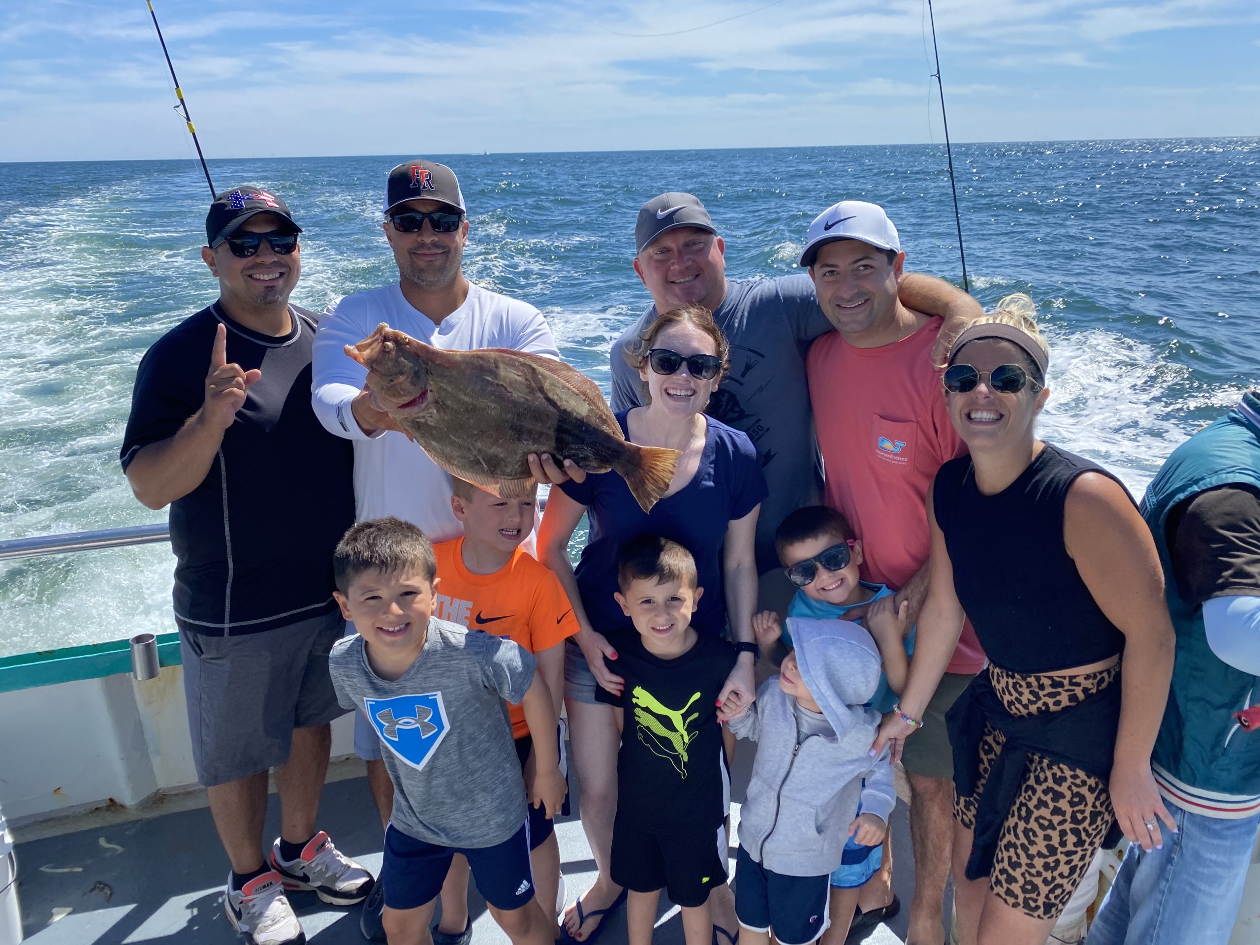 a group of people standing next to a body of water
