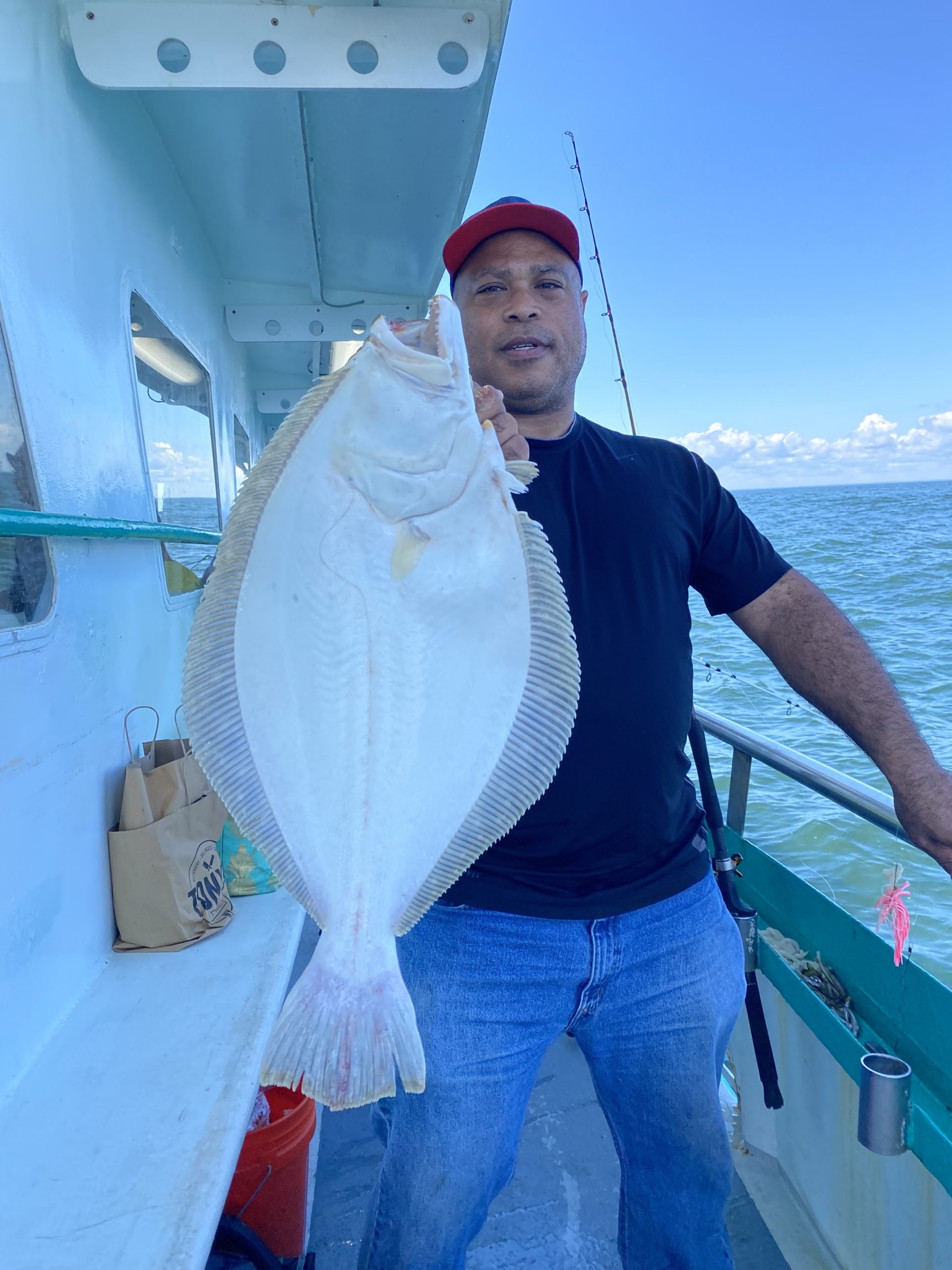 a man holding a fish on a boat