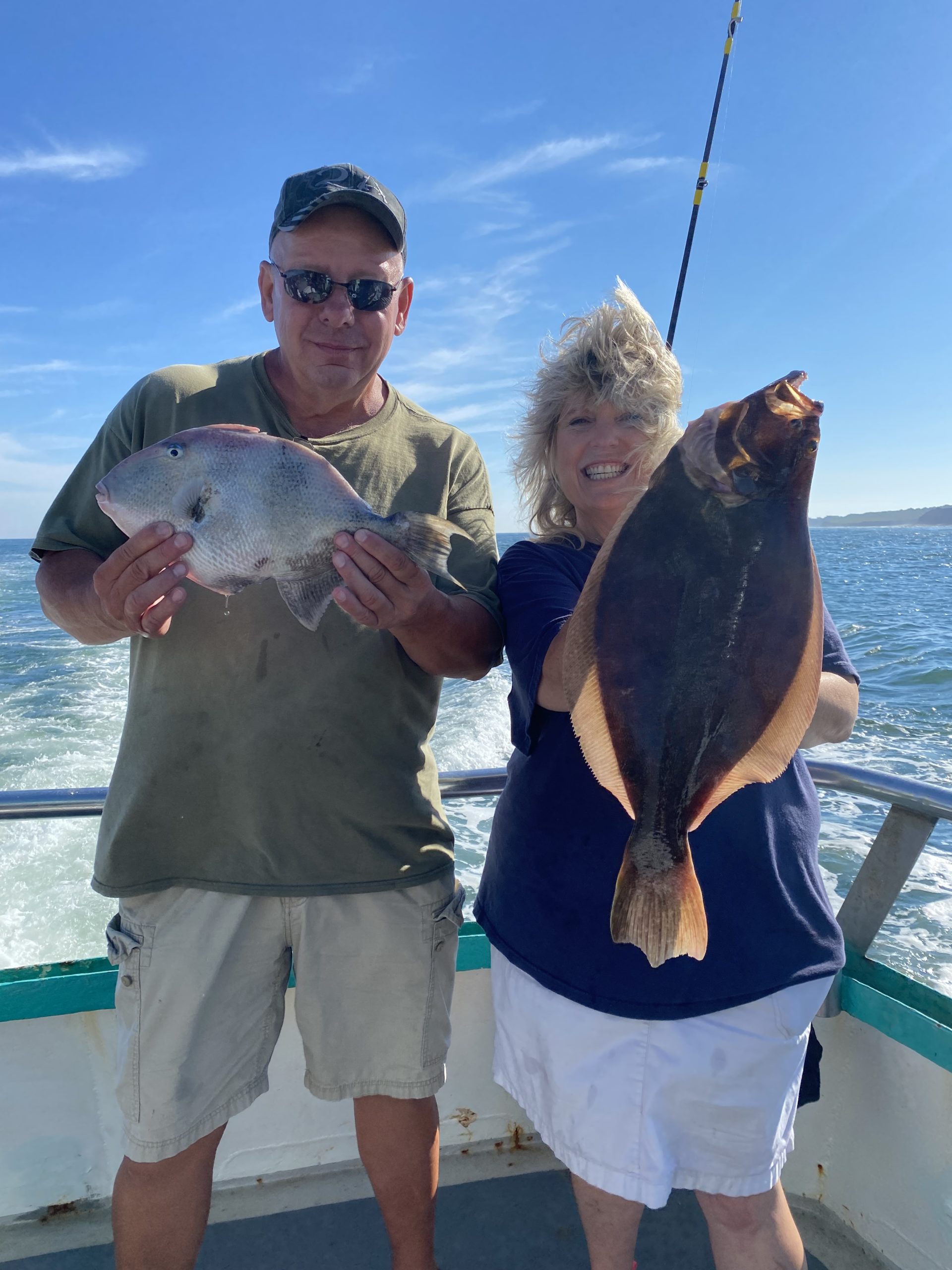 a man and a woman holding a fish