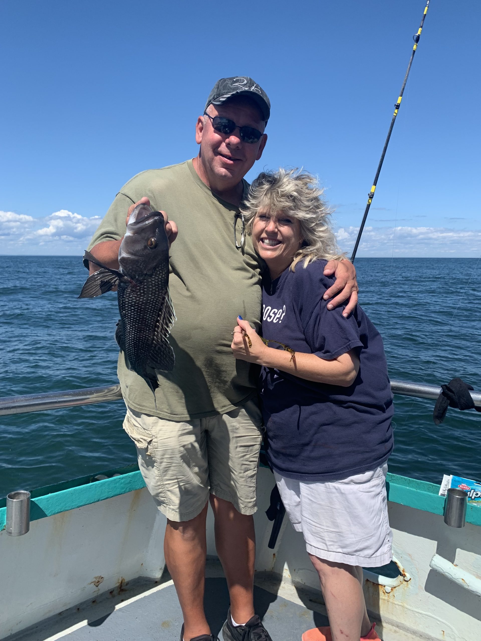 a man standing next to a body of water