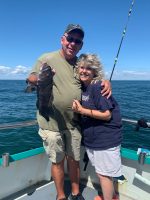 a man standing next to a body of water