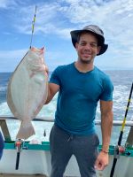 a person holding a fish in the water