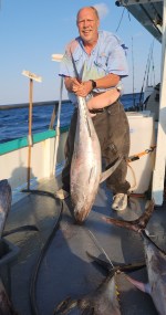 a man holding a fish