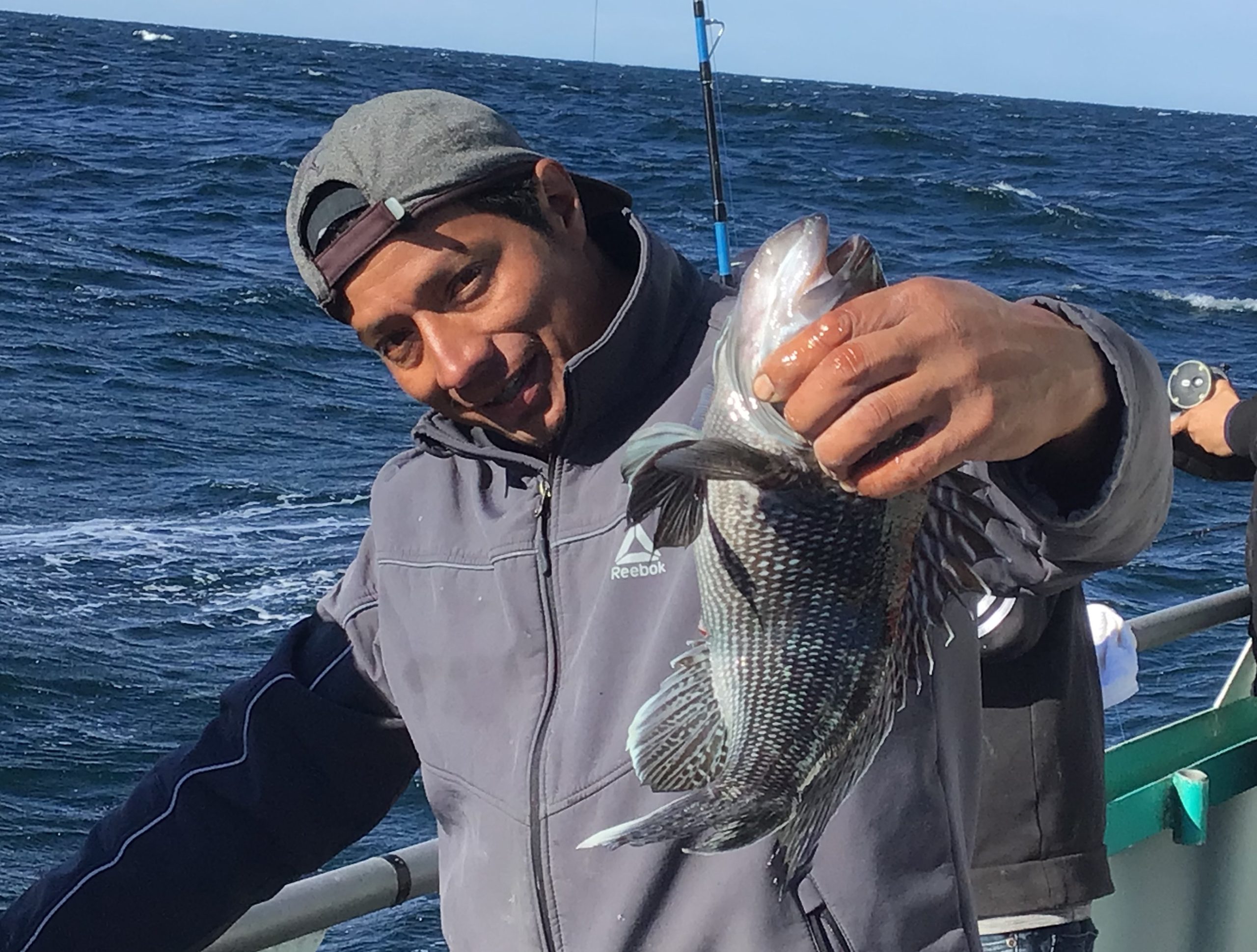 a person holding a fish in the water