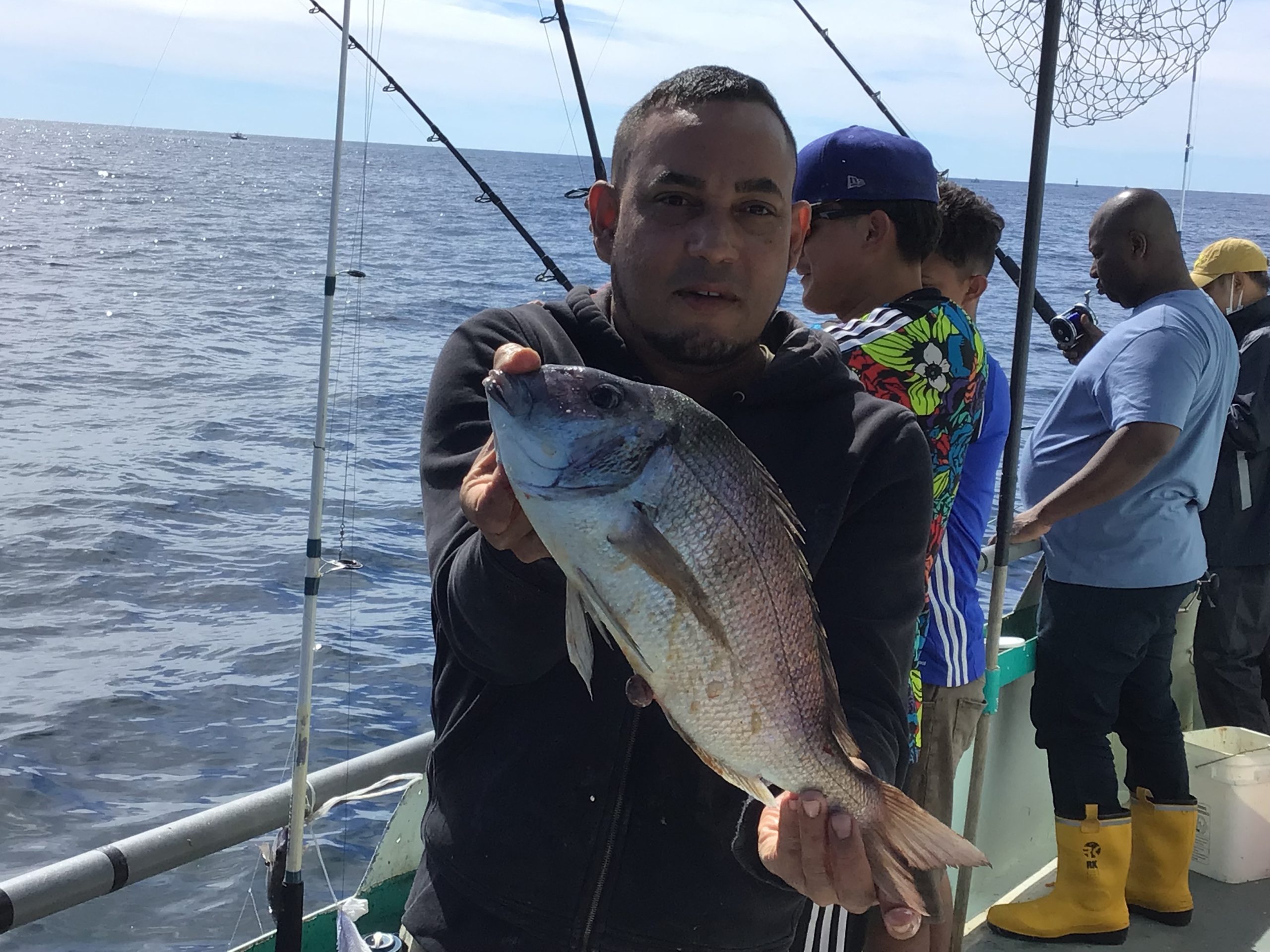 a man holding a fish in the water