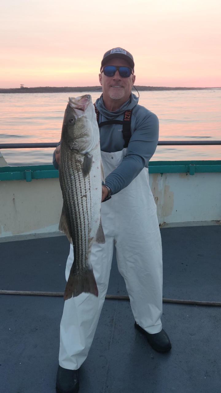 a man holding a fish in the water