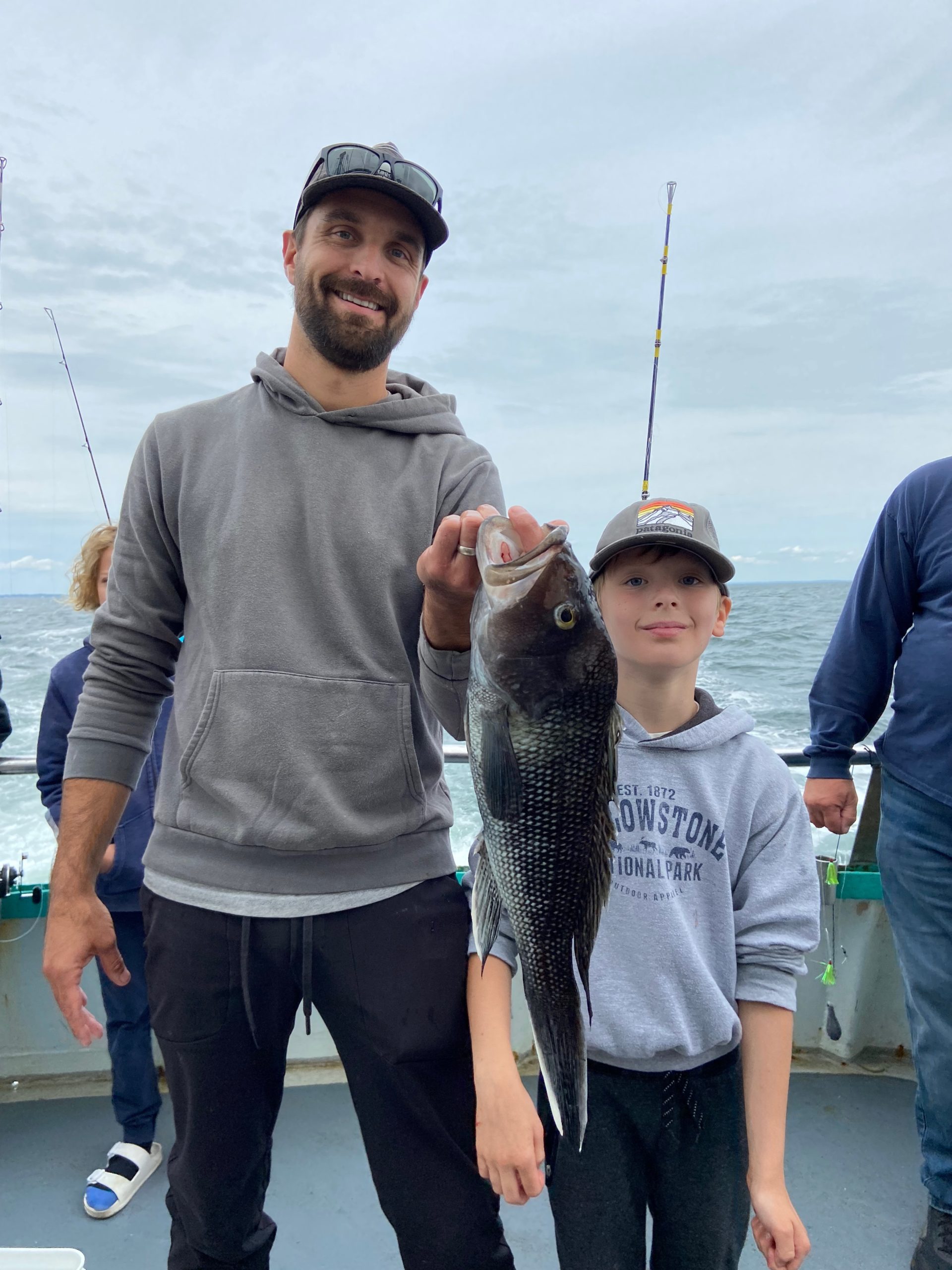 a young man holding a fish