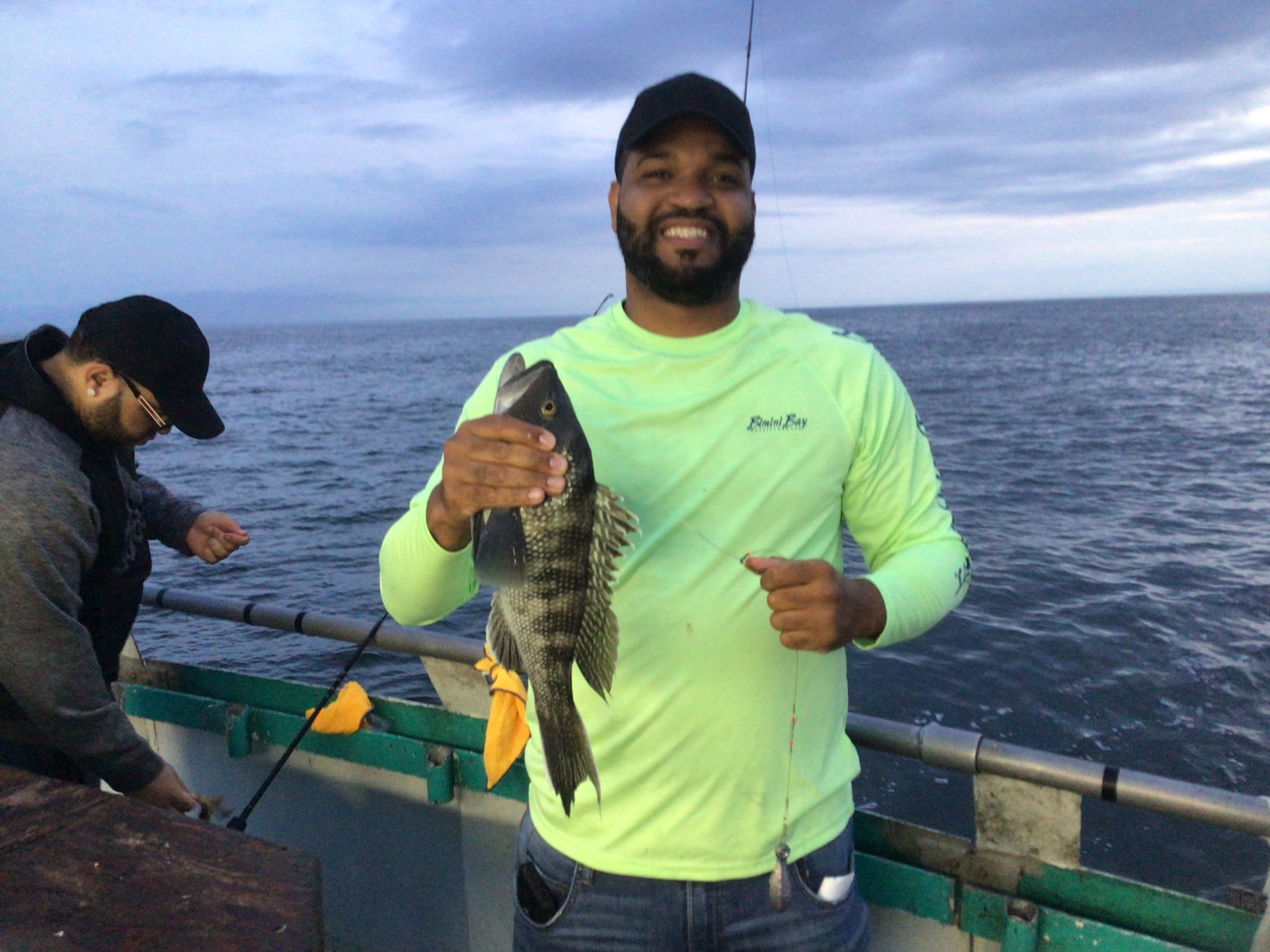 a man standing next to a body of water