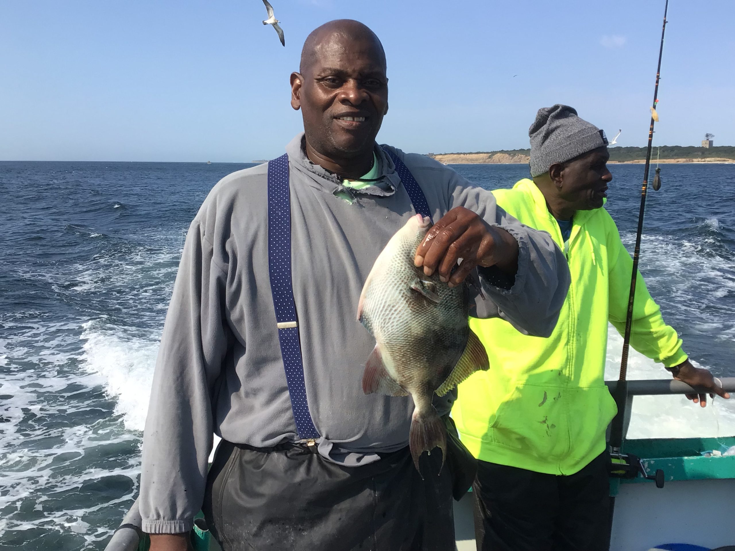 a man holding a fish in the water