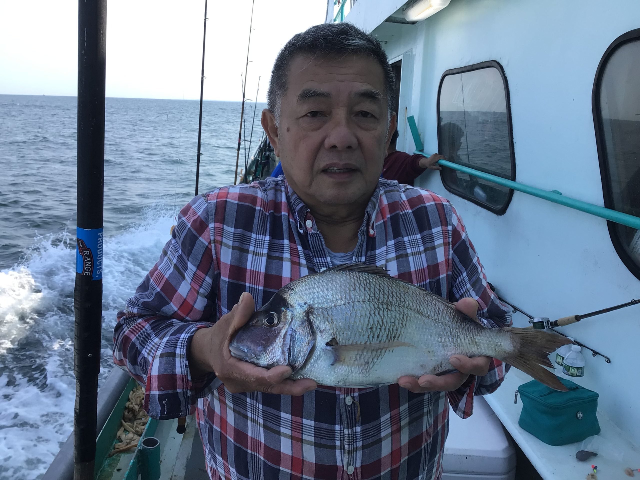 a man holding a fish in the water