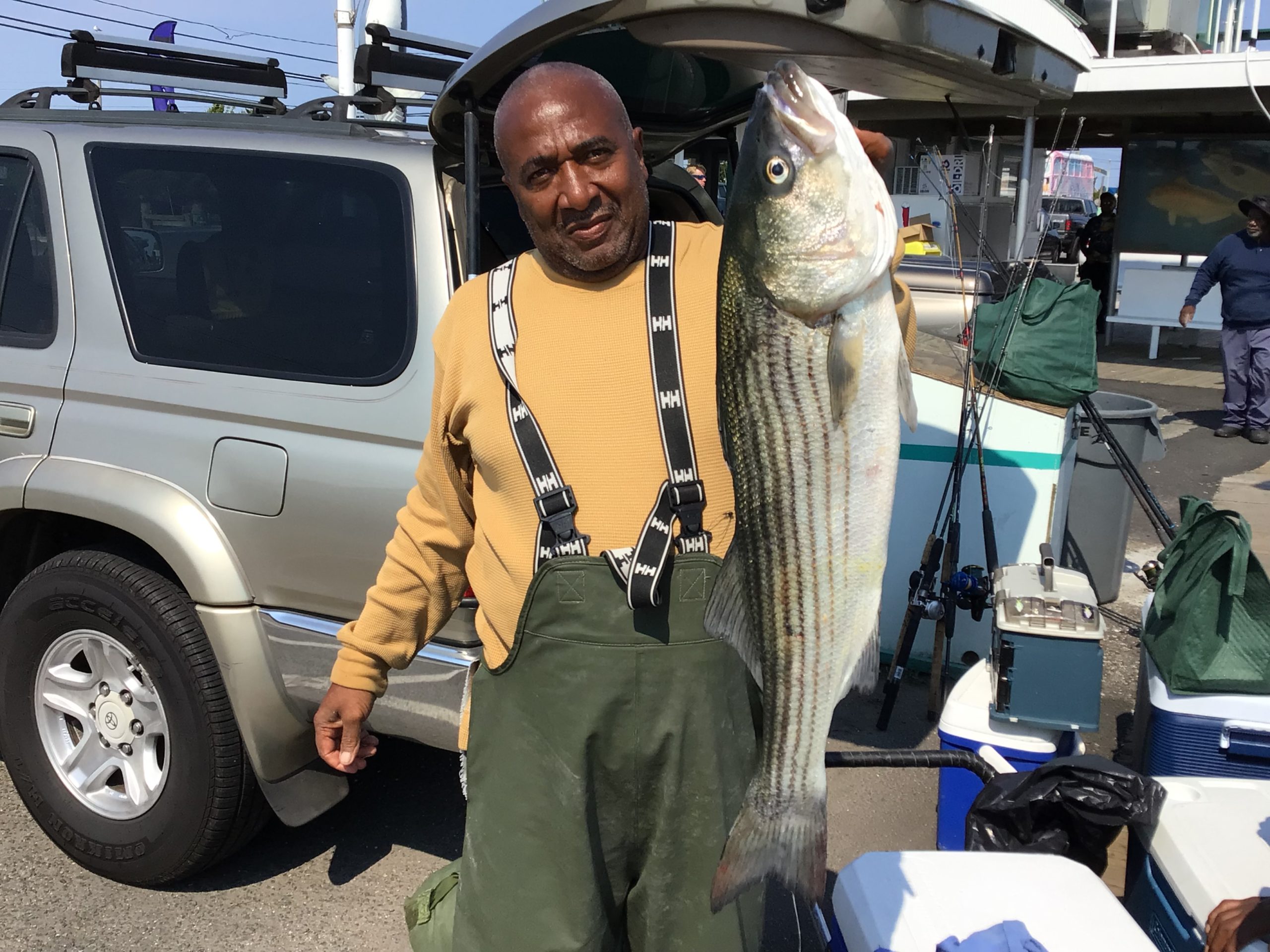 a man and a woman standing in front of a fish