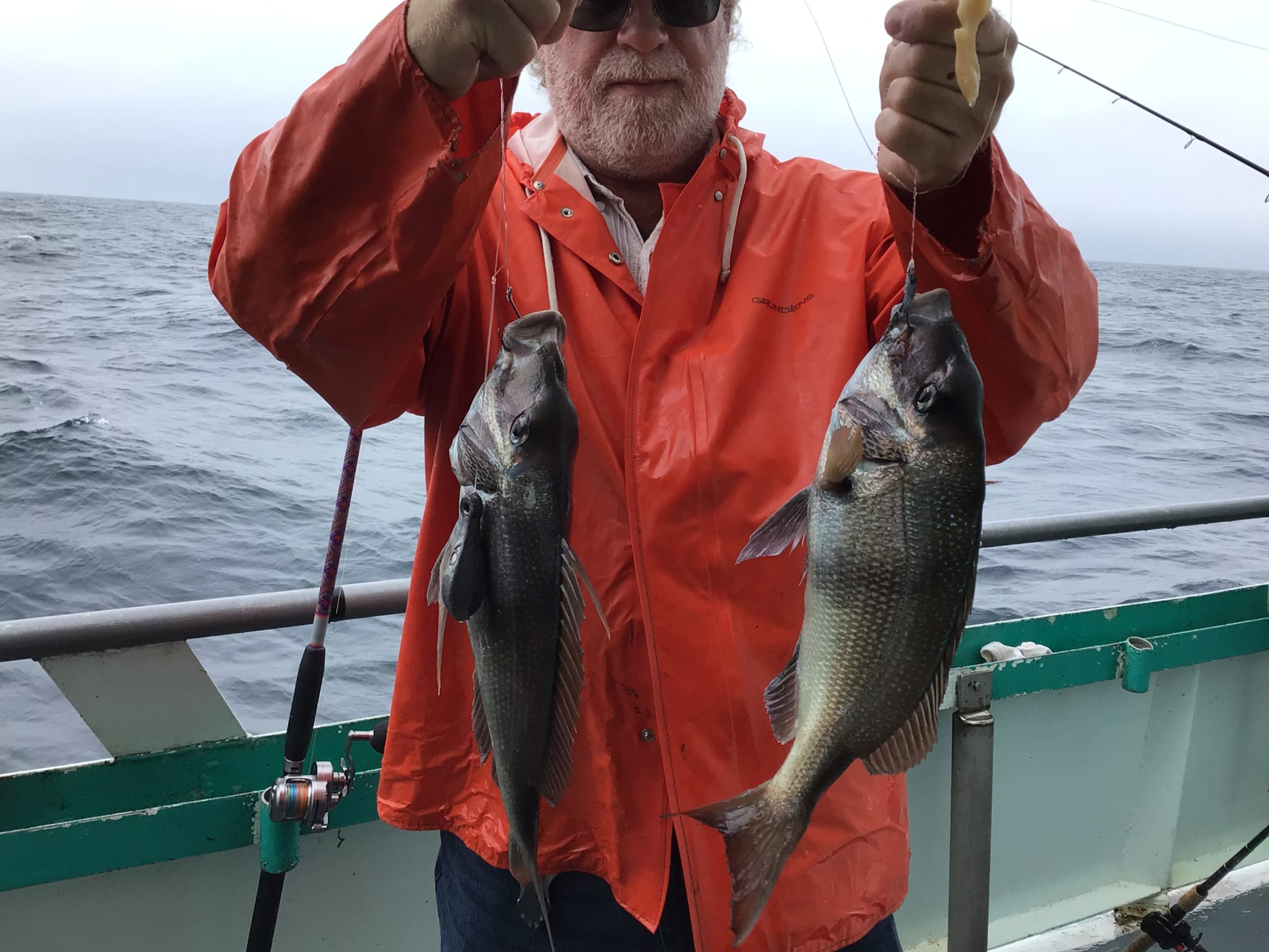 a man holding a fish in the water