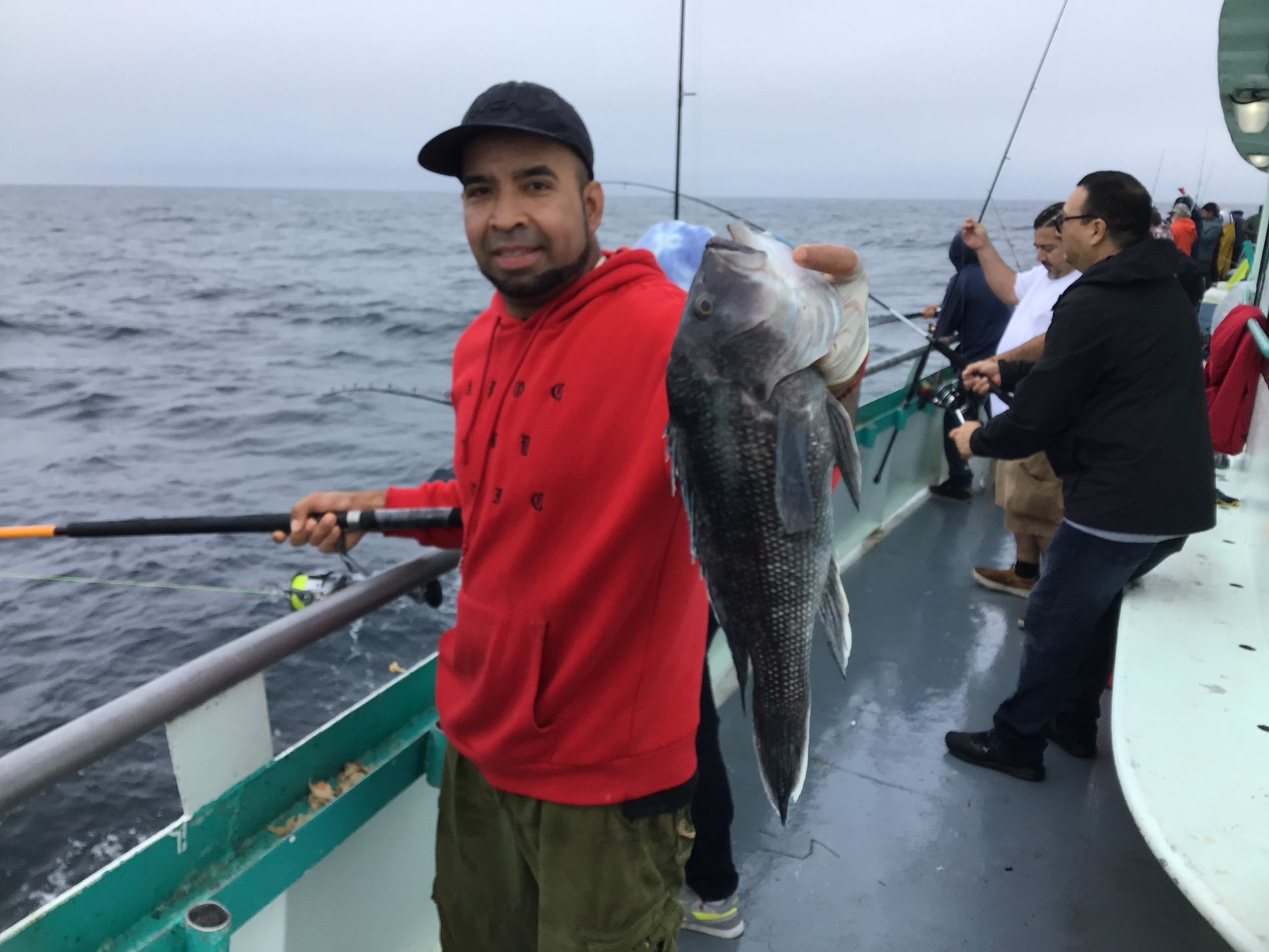 a man standing next to a body of water