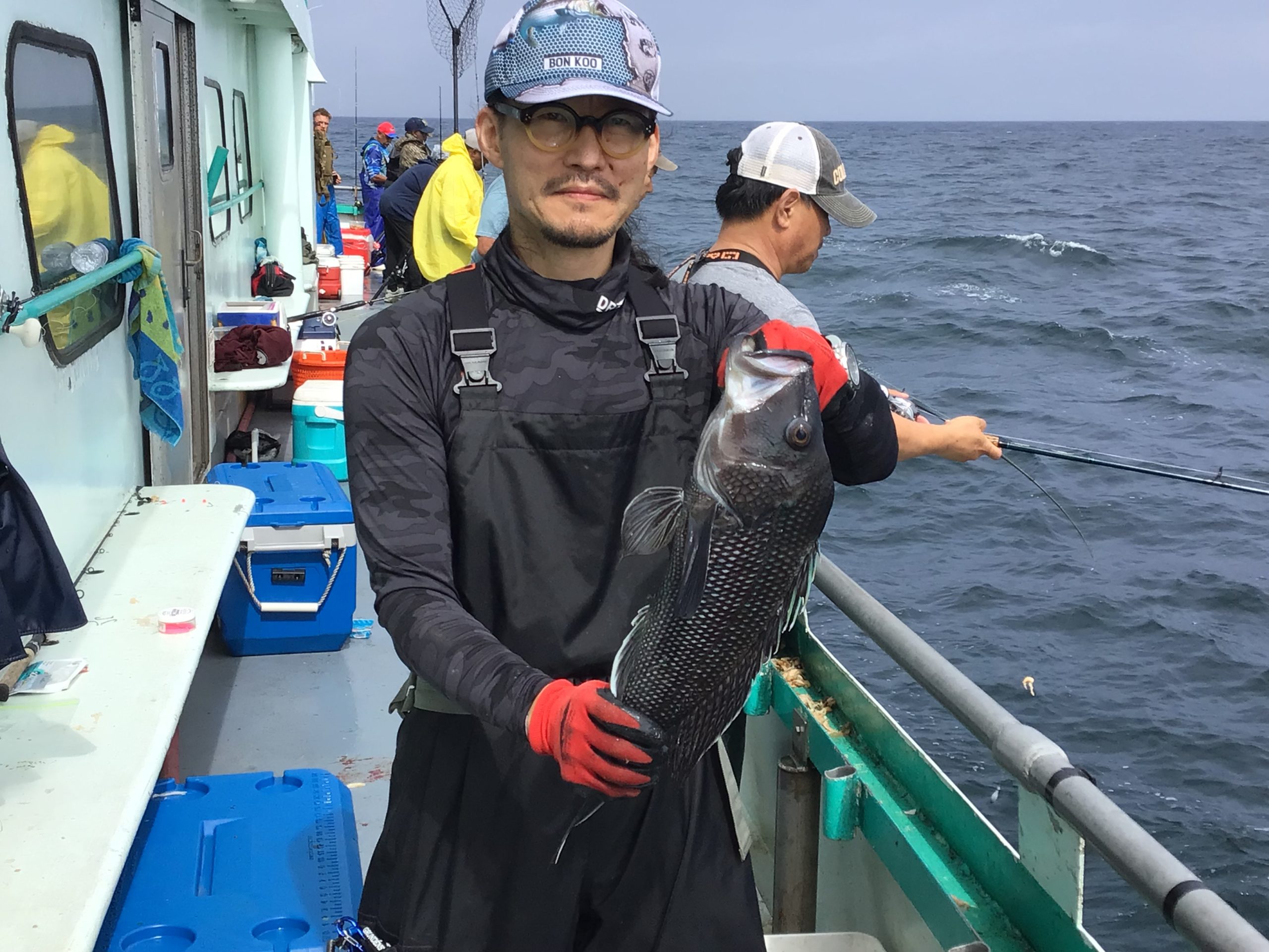 a man and a woman standing on a boat in the water