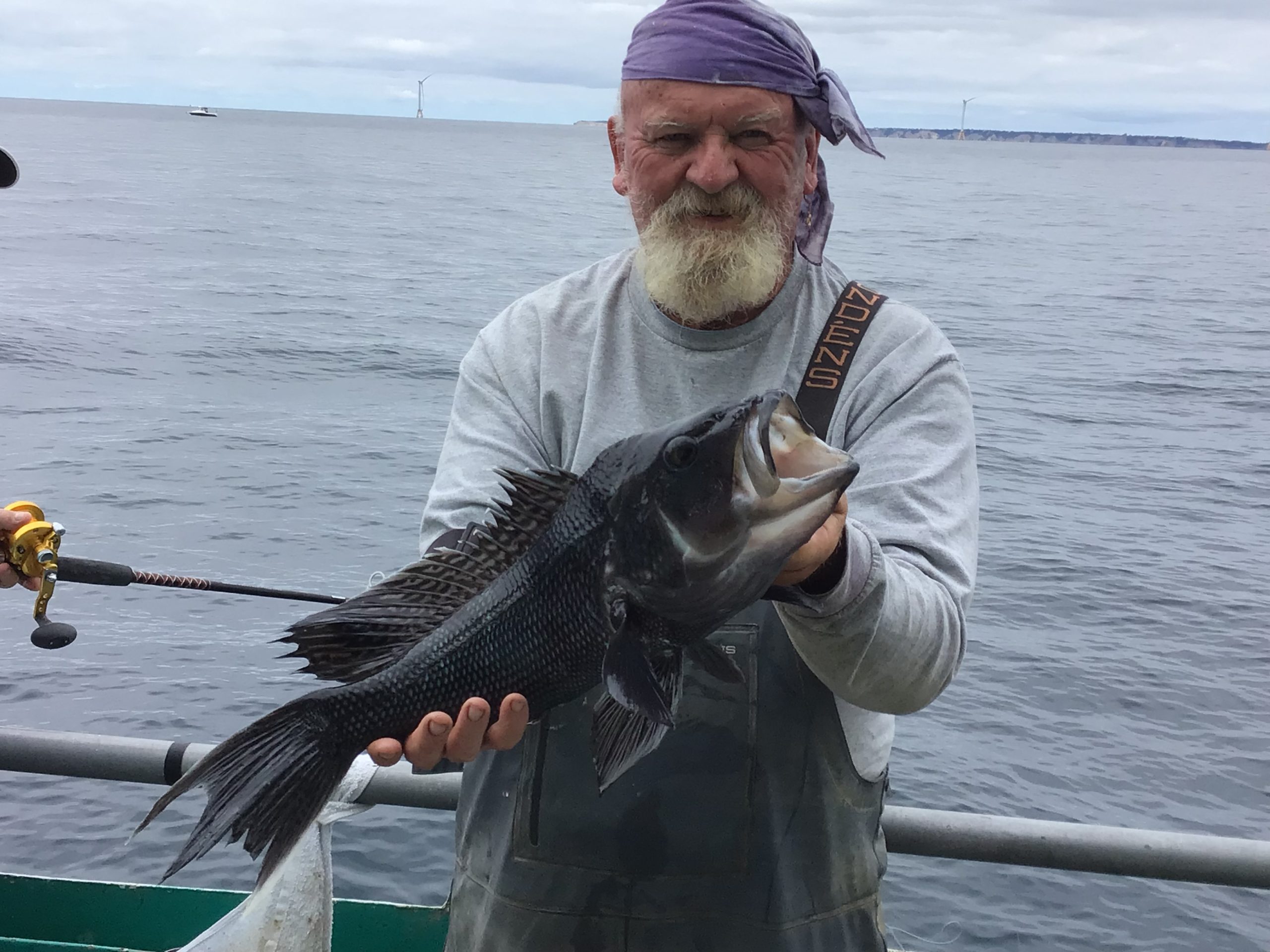 a man holding a fish in the water