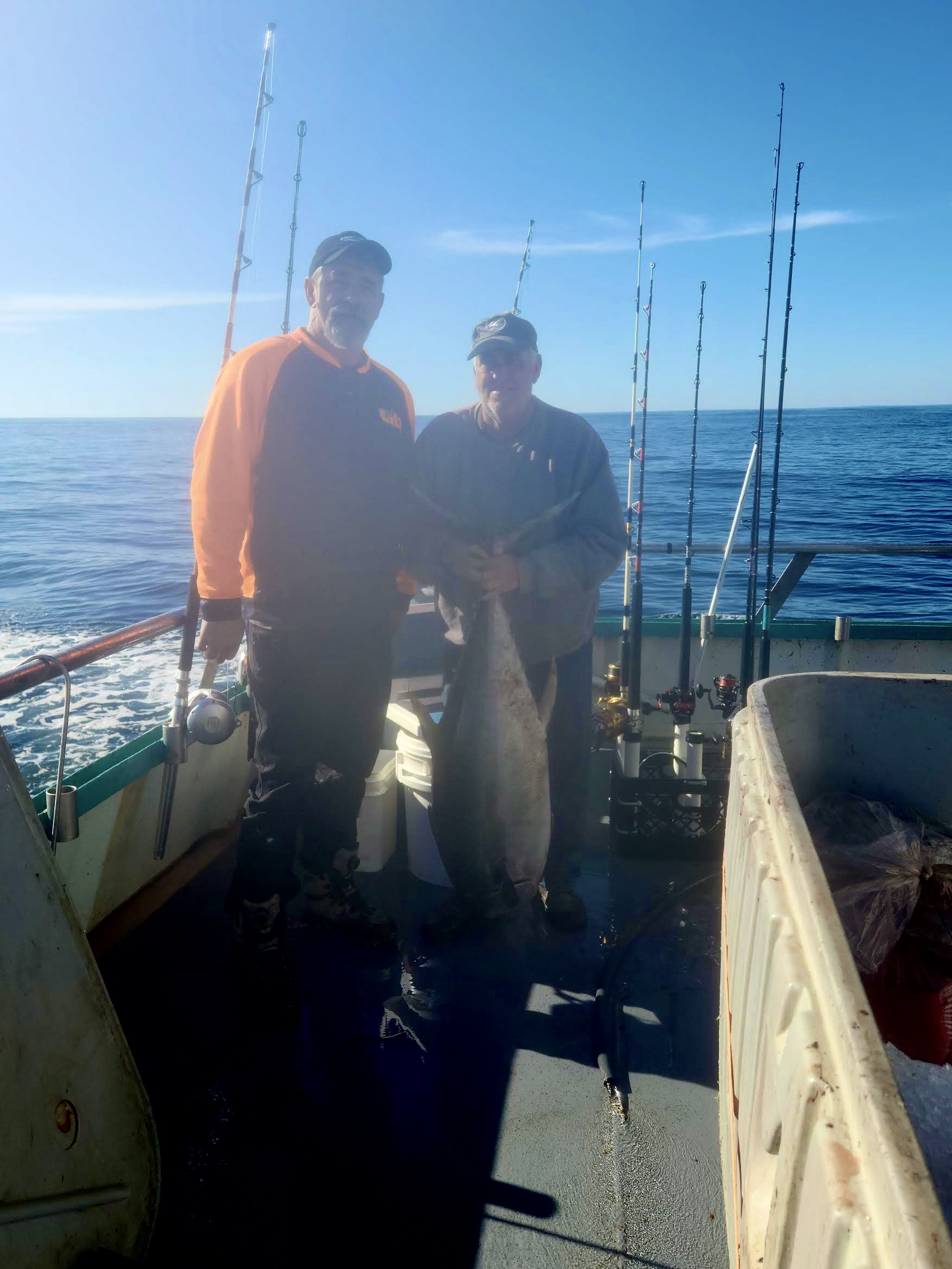 a man standing next to a body of water