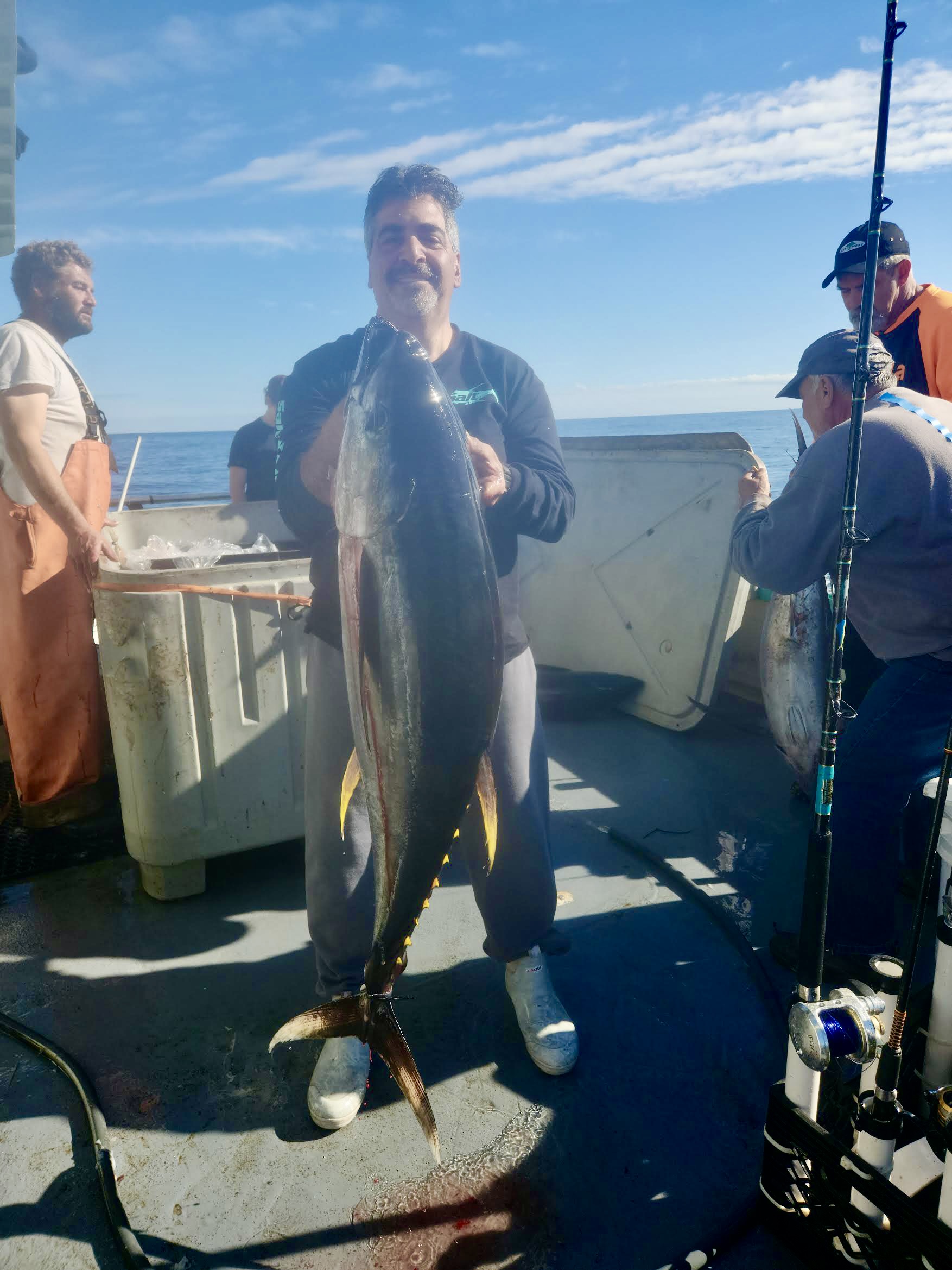 a man holding a fish in the water