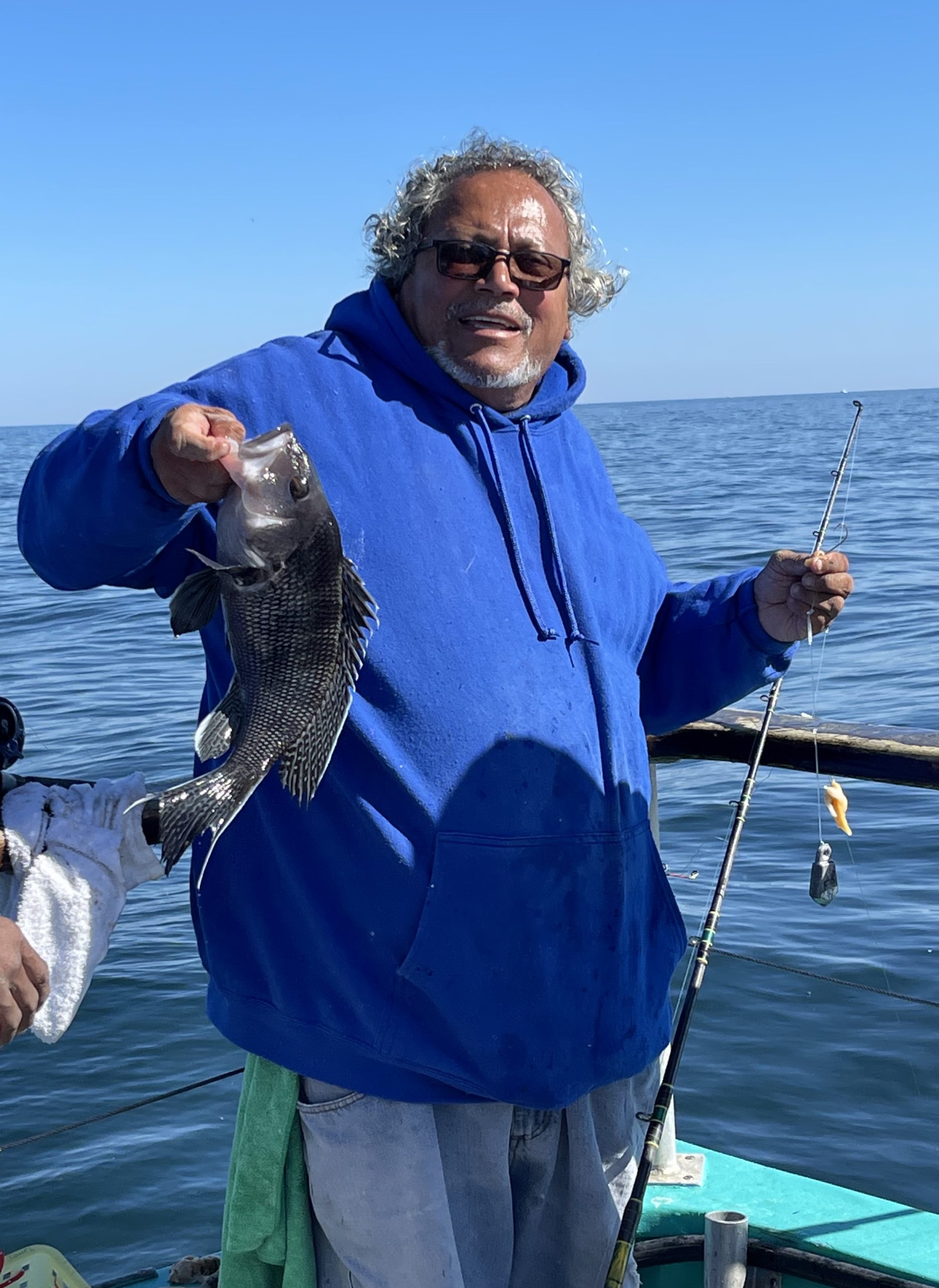 a person holding a fish on a boat in the water