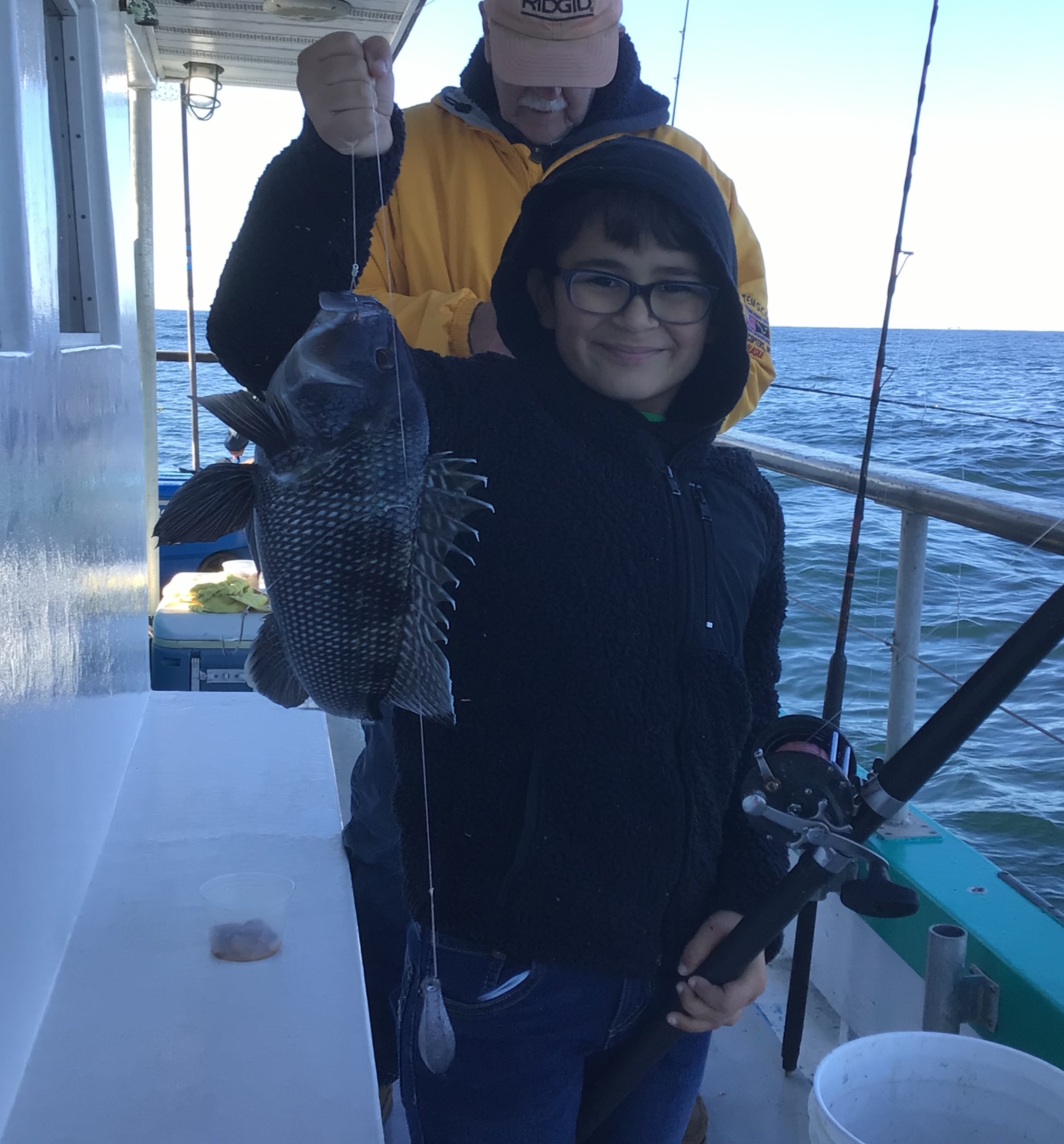 a man and a woman standing on a boat